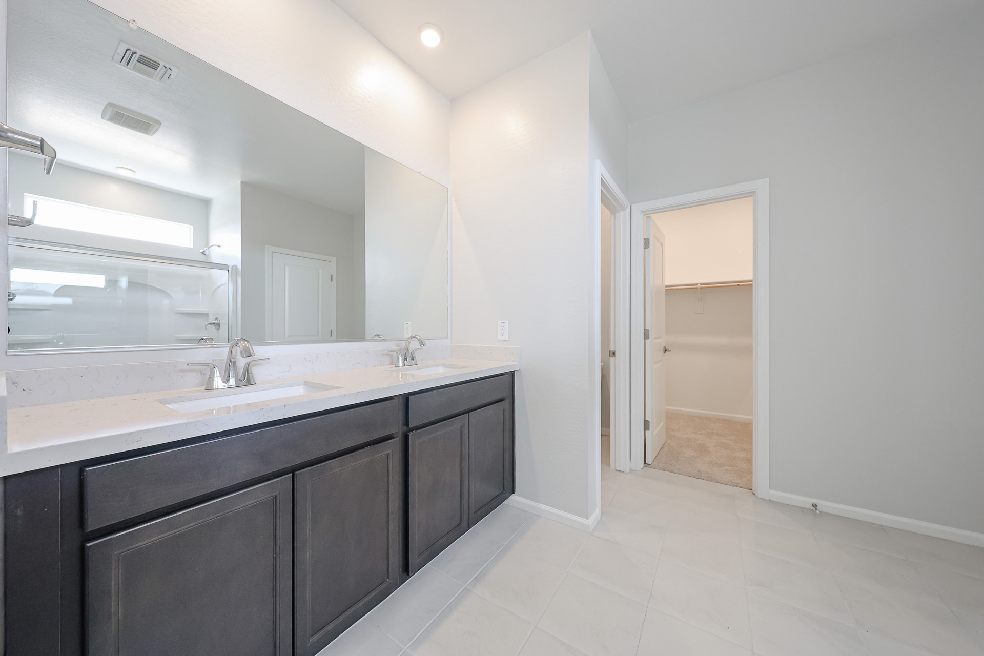 A bathroom with a large mirror.