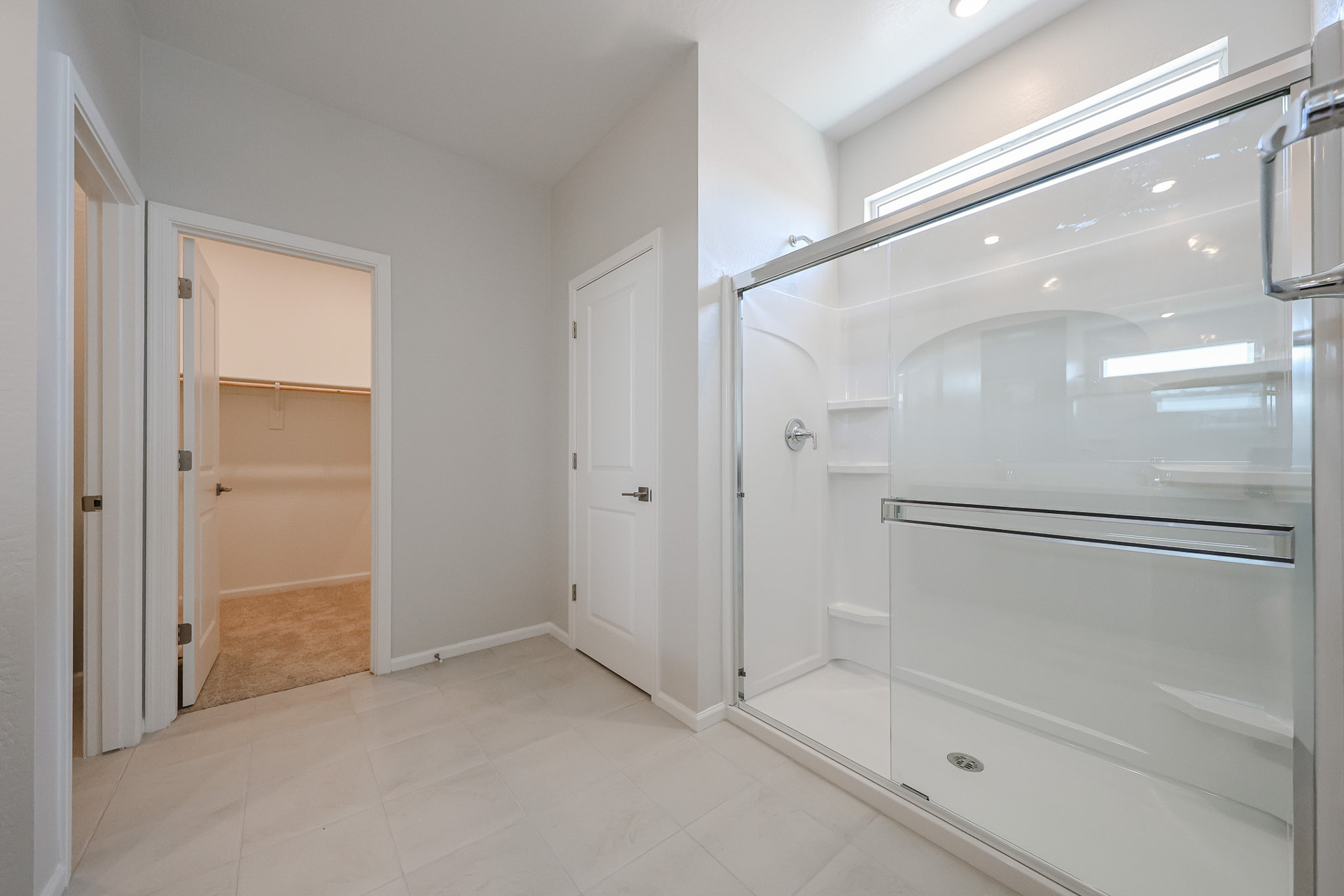 A bathroom with white cabinets.