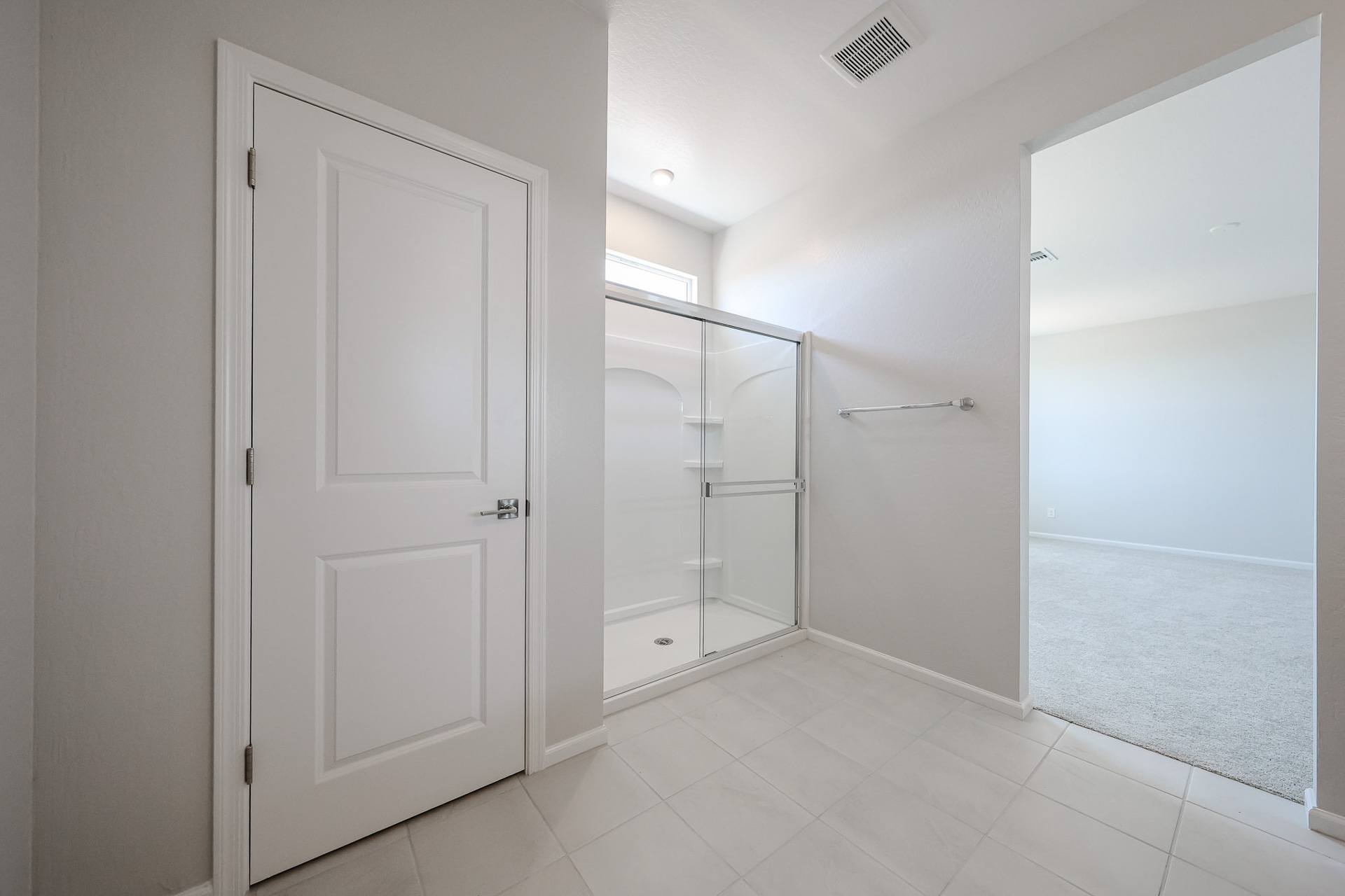 A bathroom with white doors.