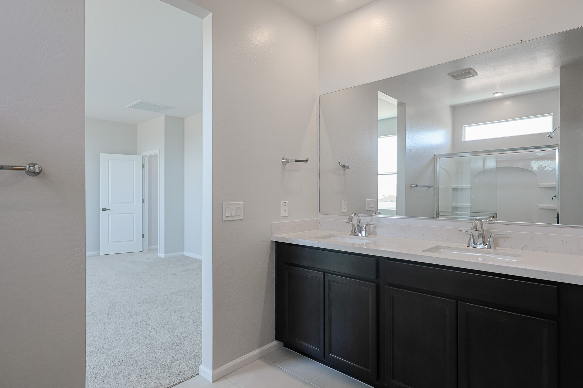 A bathroom with a large mirror.