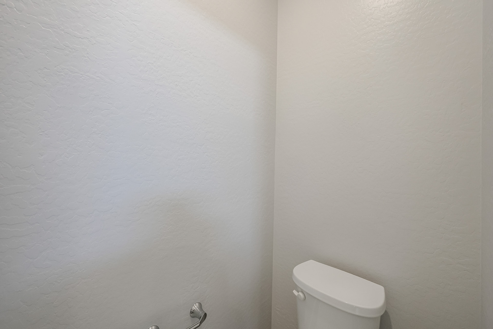 A toilet in a bathroom.