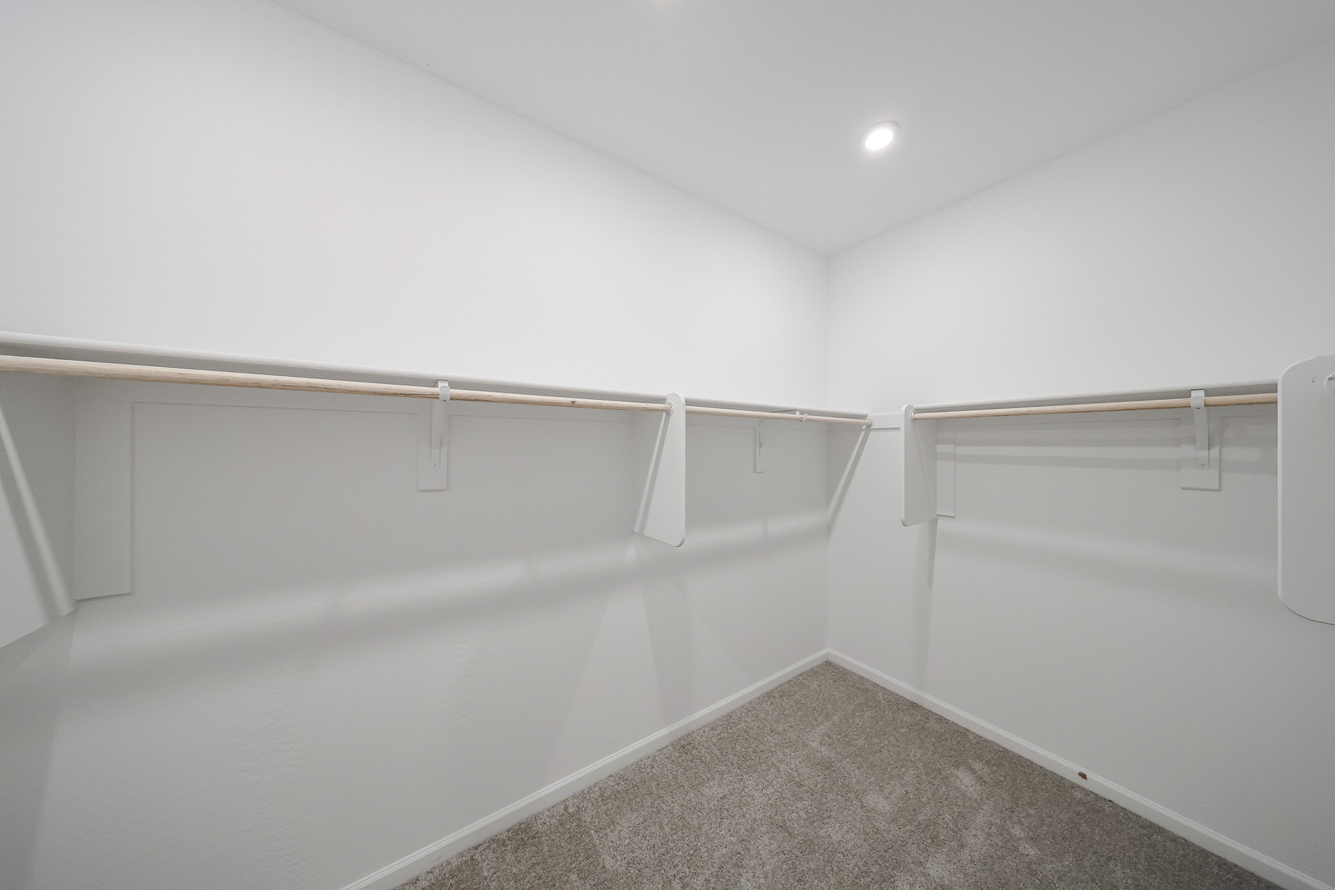 A white room with a metal railing.
