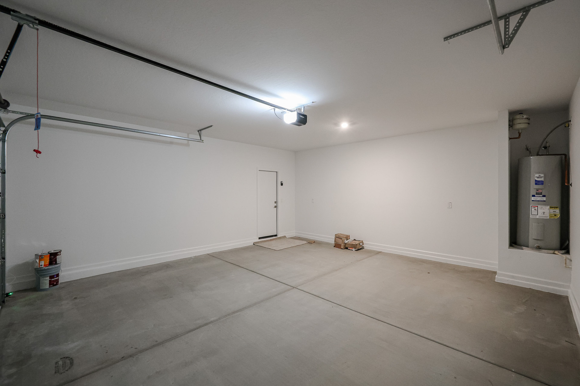 A room with a white wall and a metal box with a light.