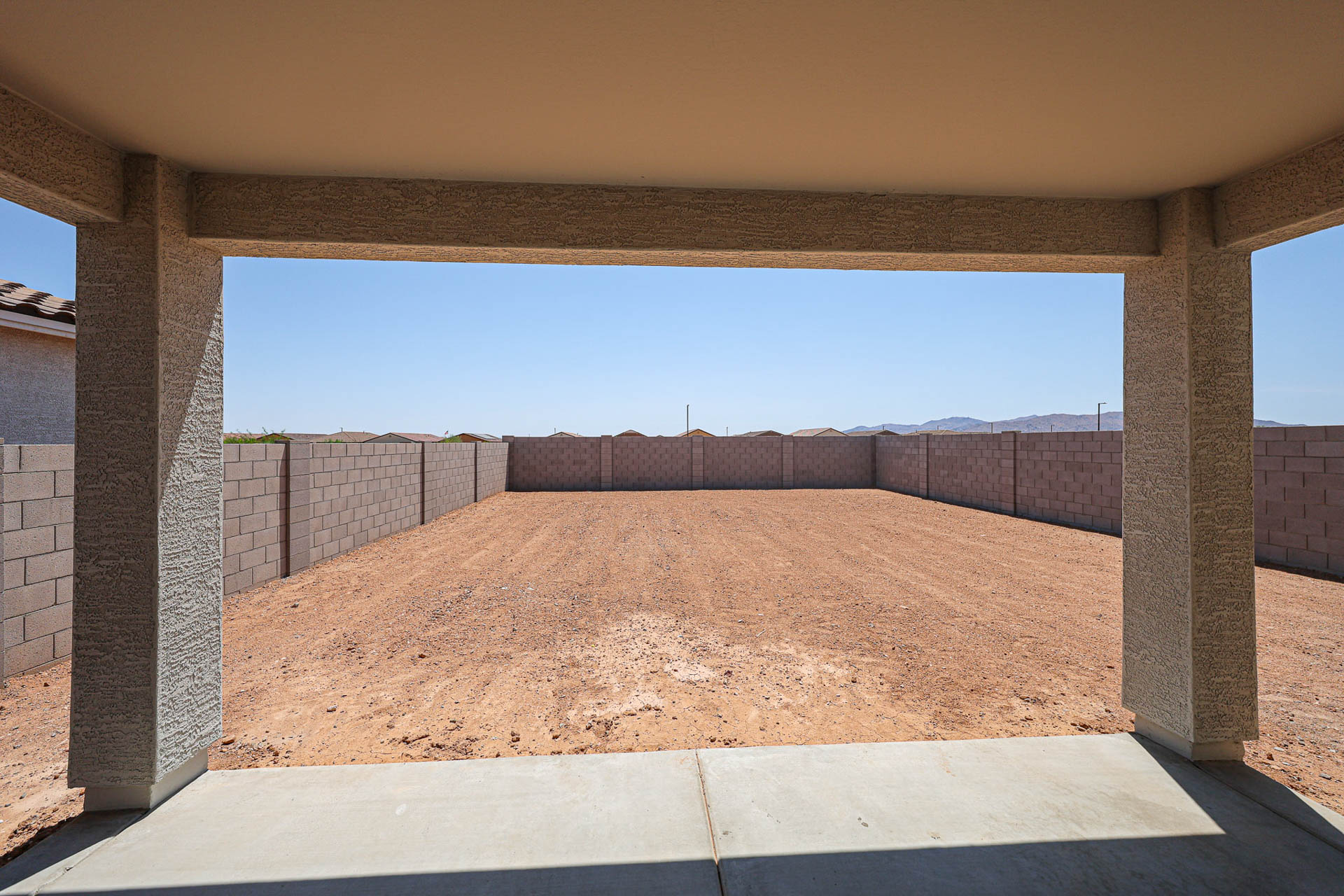 A large brick wall with a fence.