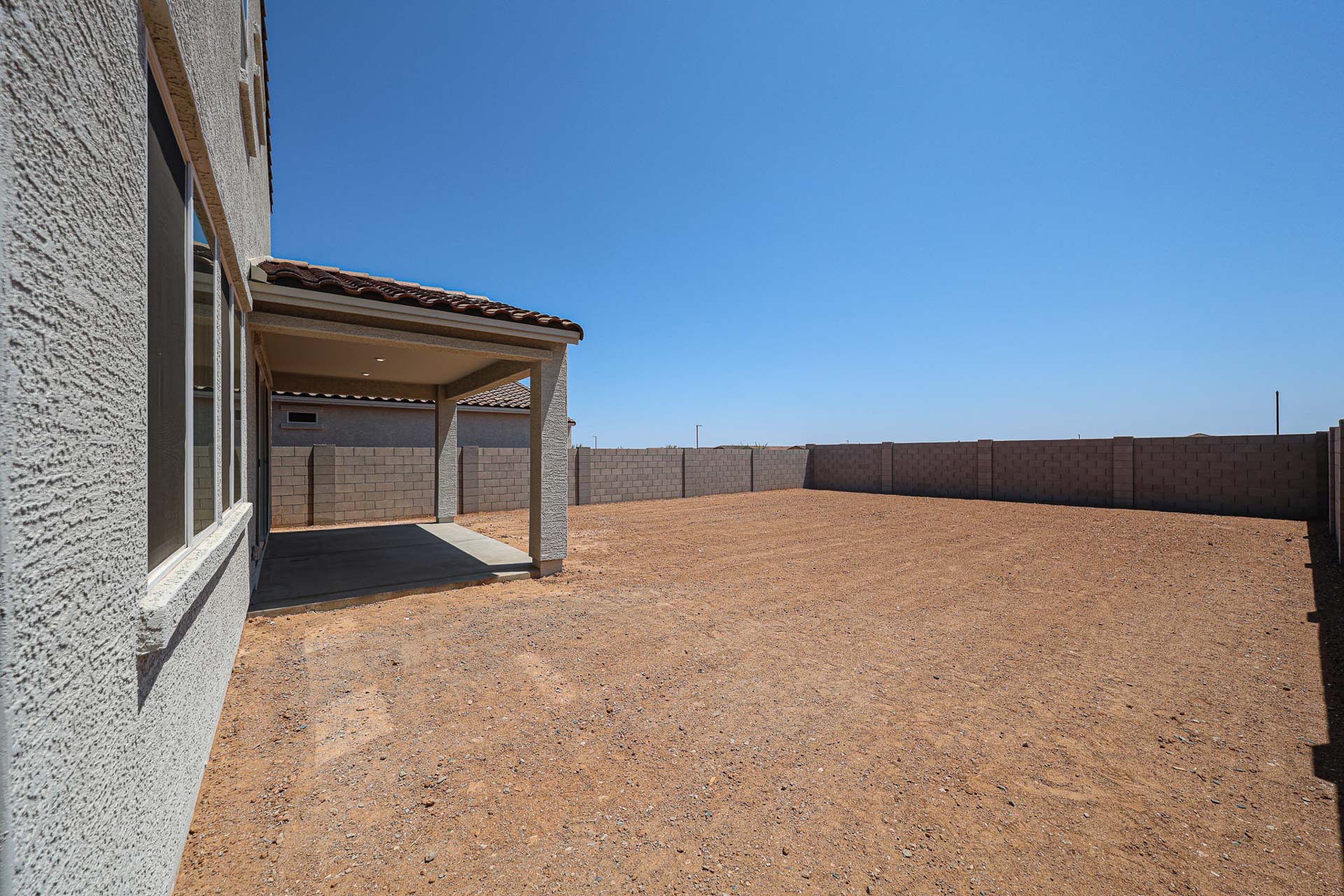 A dirt road between buildings.