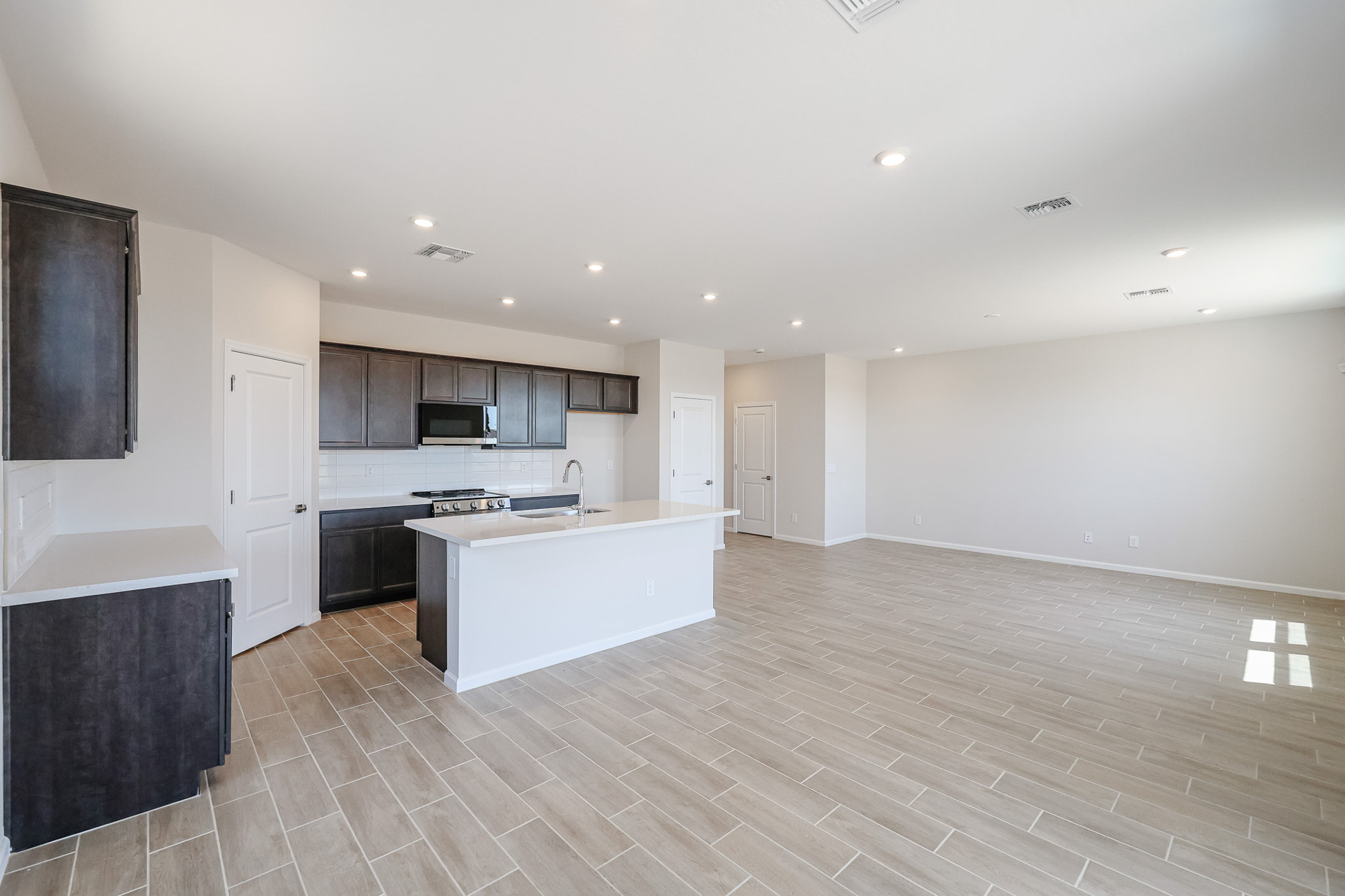 A large kitchen with black cabinets.
