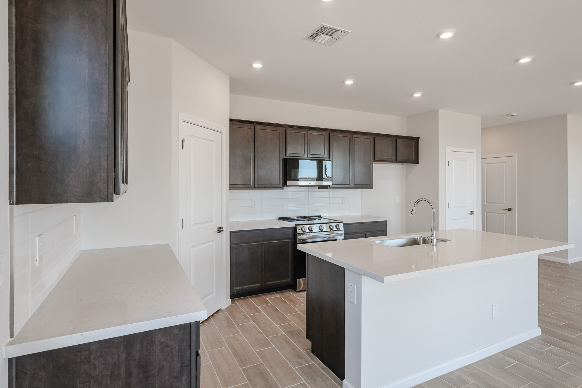 A kitchen with black cabinets.