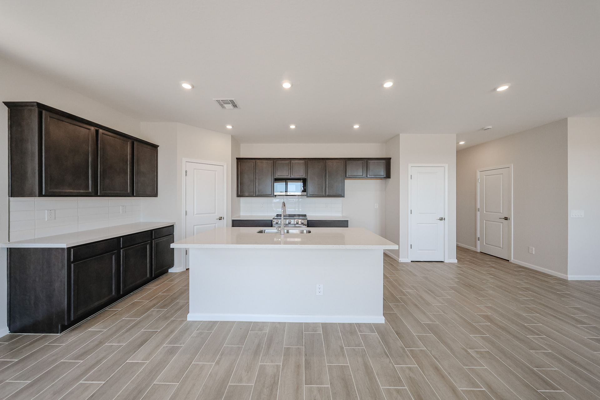 A kitchen with black cabinets.