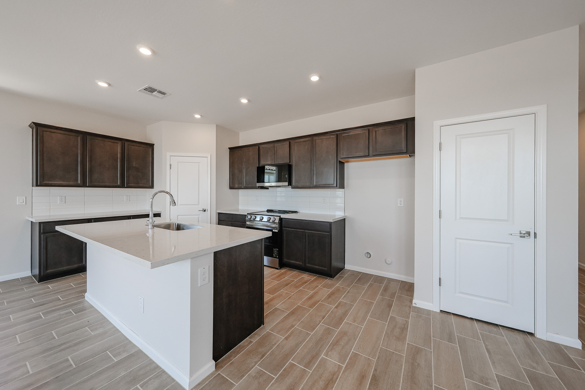 A kitchen with wooden cabinets.