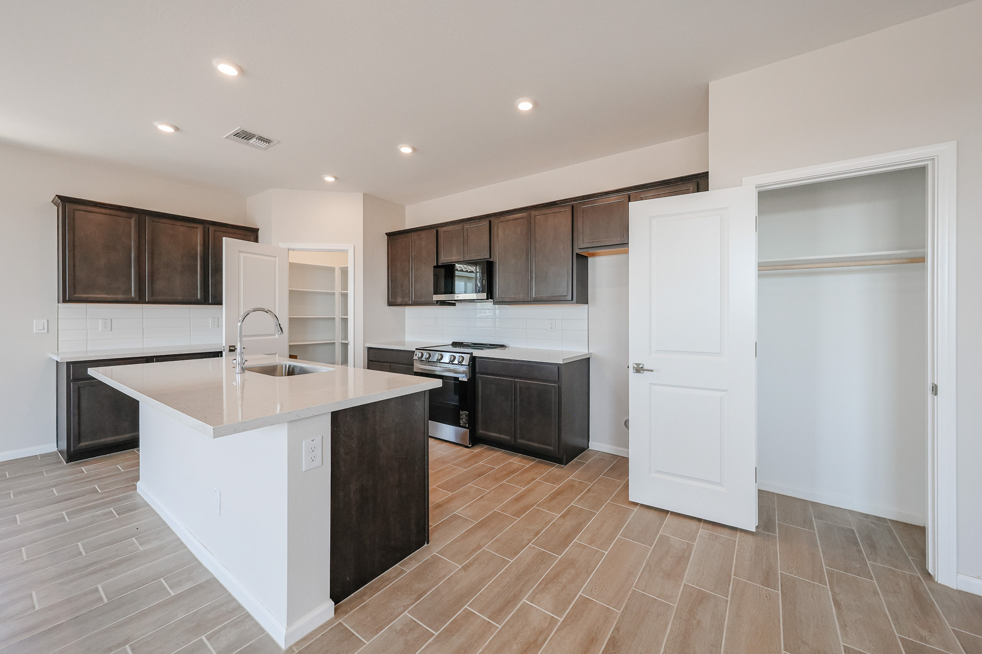 A kitchen with wooden cabinets.