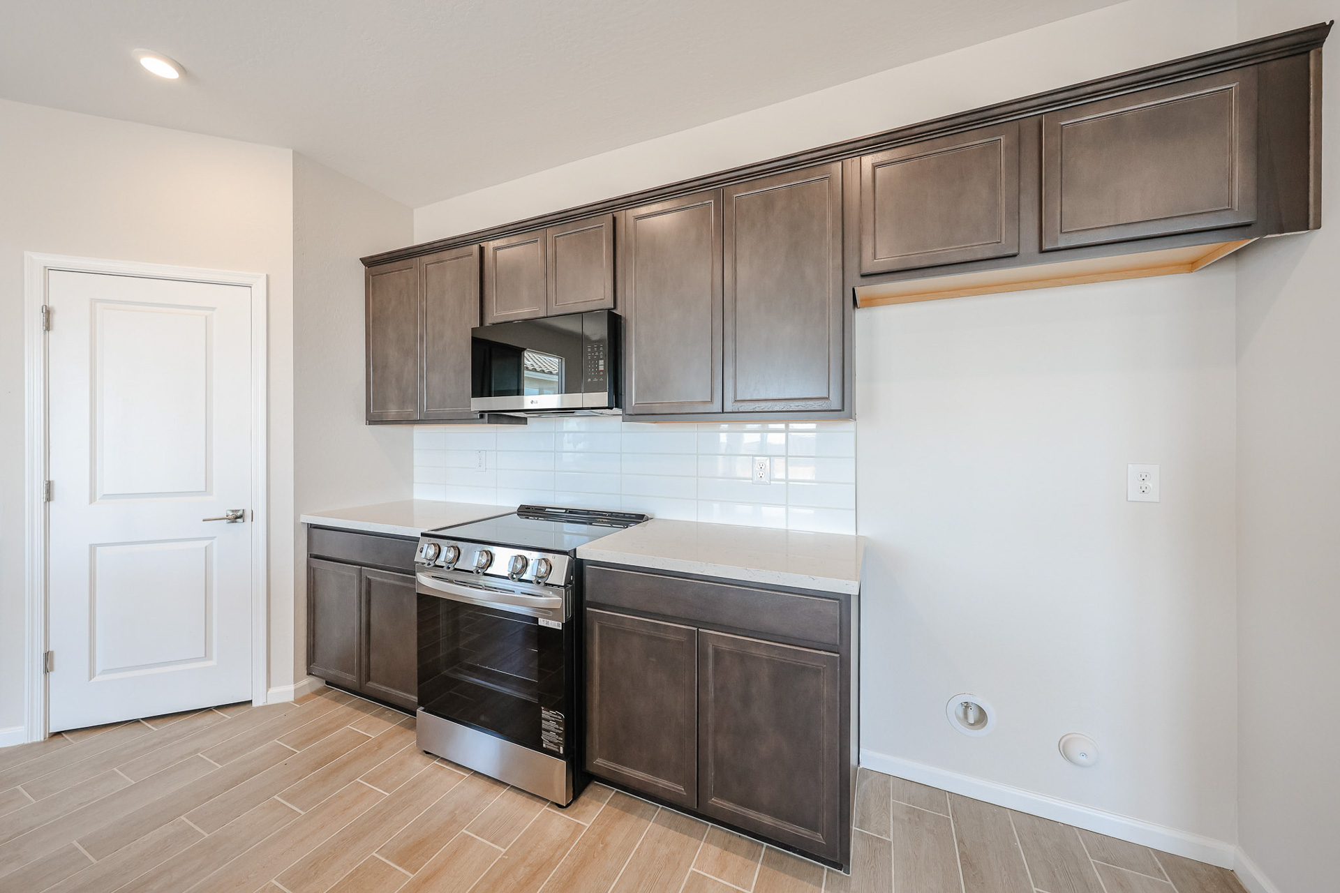 A kitchen with wooden cabinets.