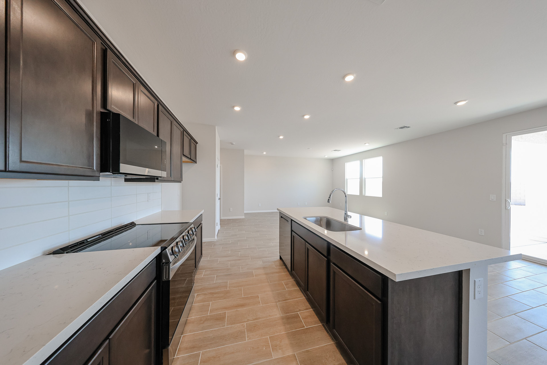 A kitchen with black cabinets.