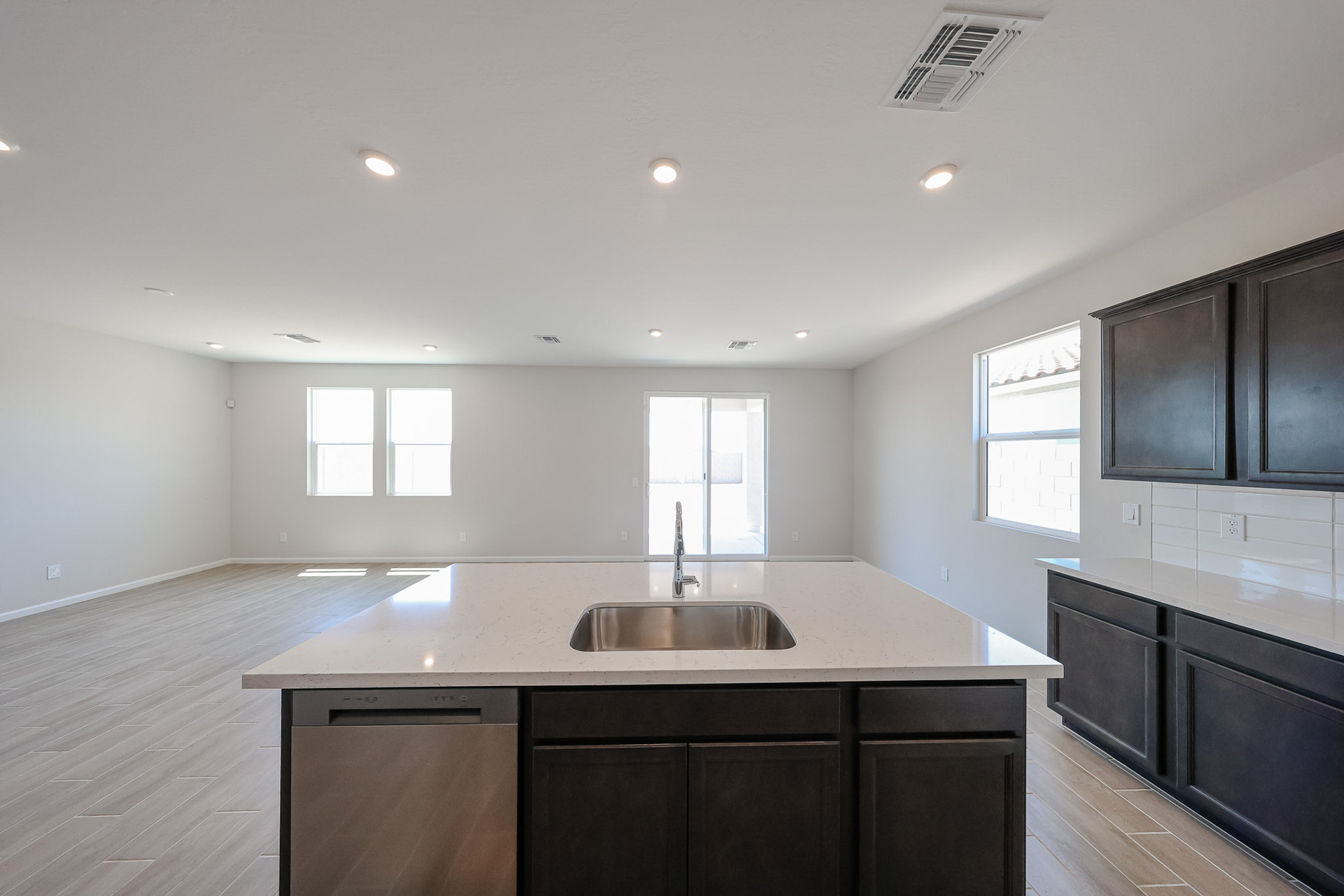 A kitchen with black cabinets.