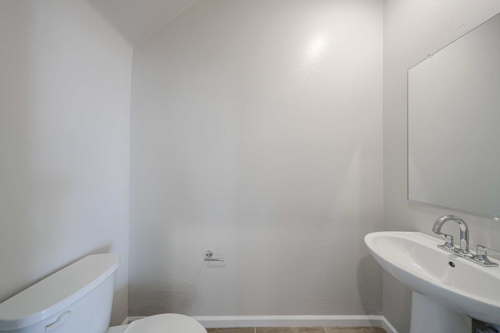 A bathroom with a sink and toilet.