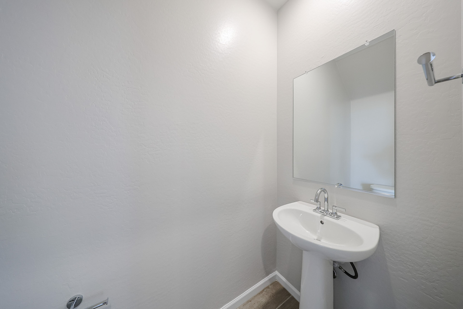 A bathroom with a mirror and sink.