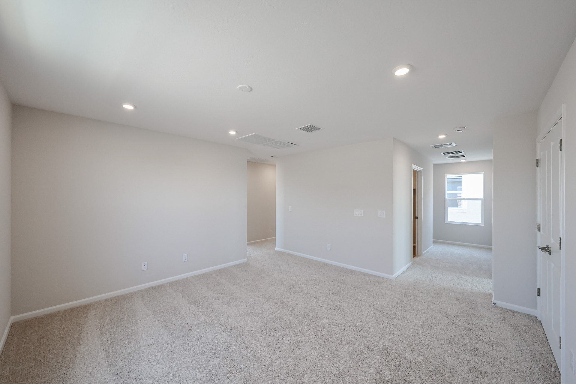 A long hallway with white walls.