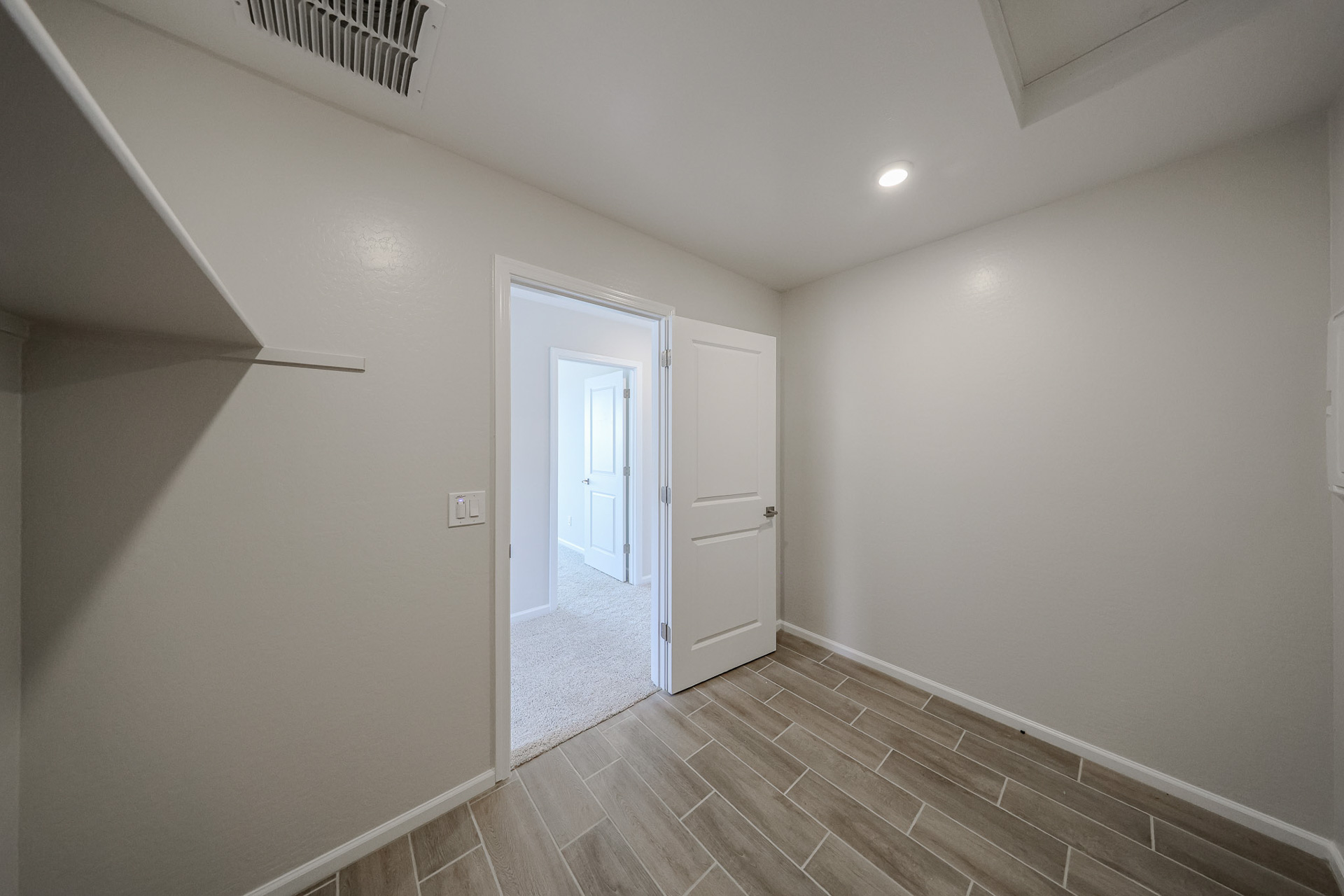 A hallway with white walls.