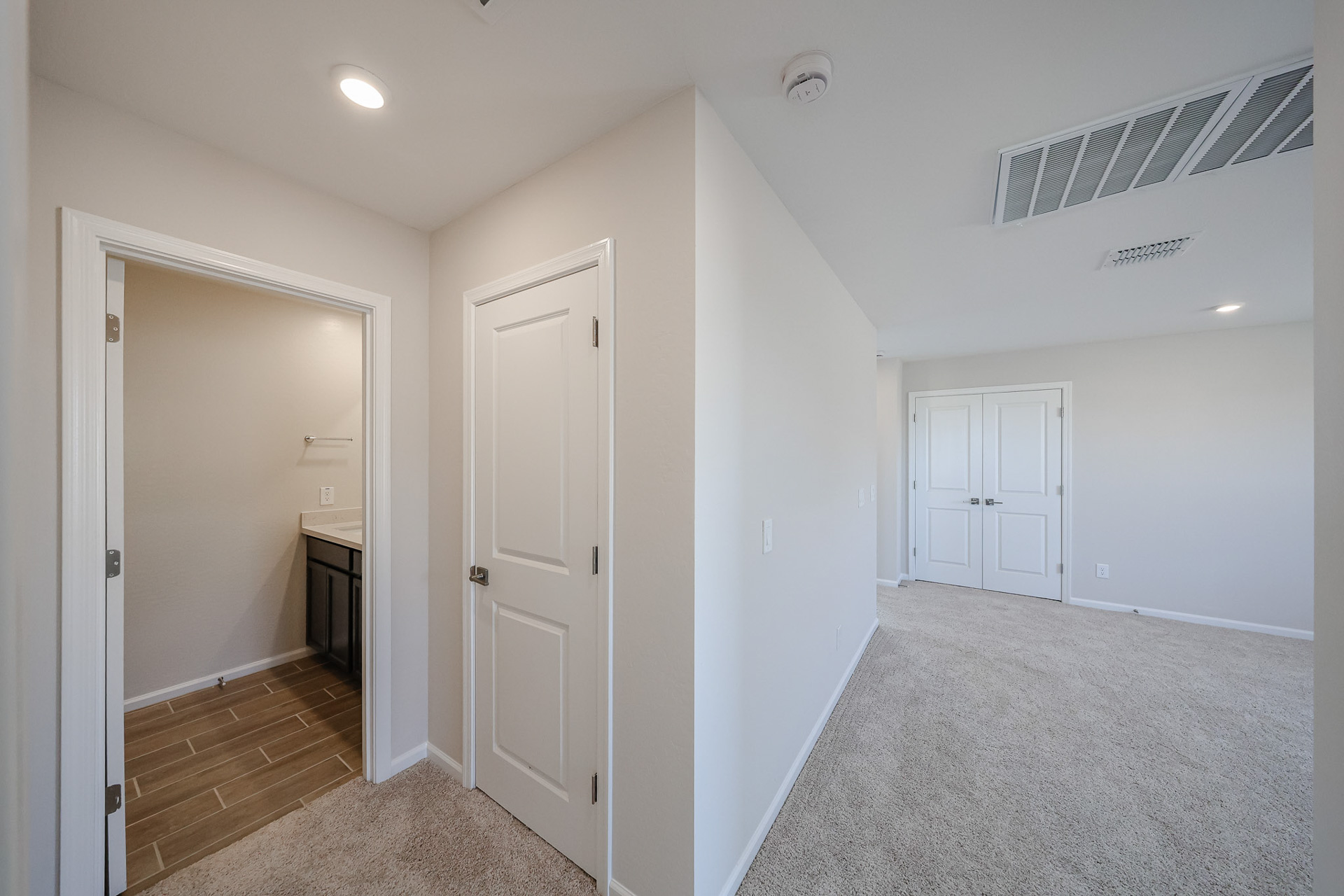 A hallway with white doors.