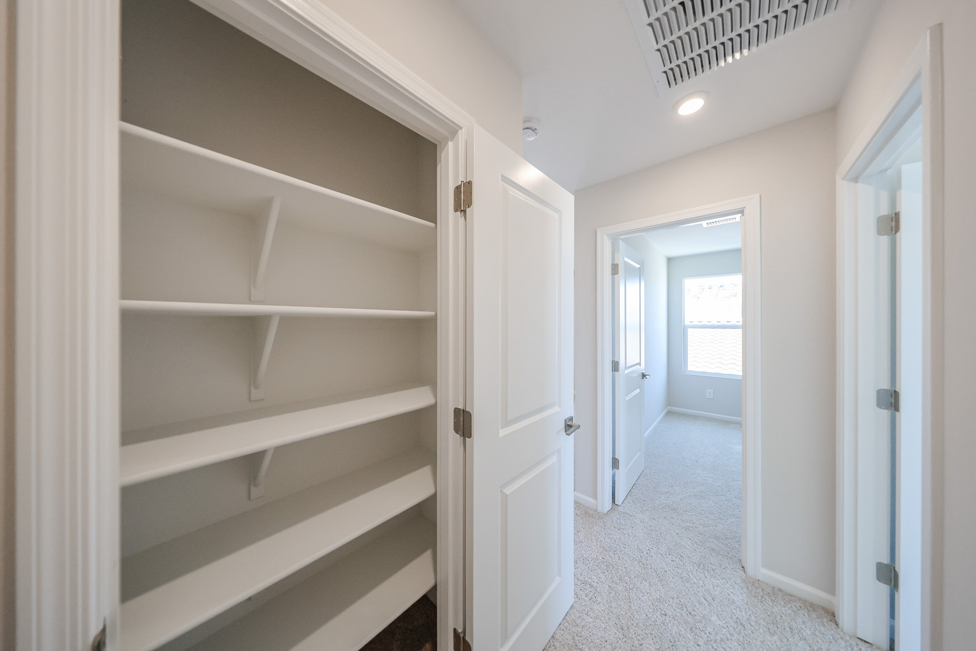 A hallway with white doors.