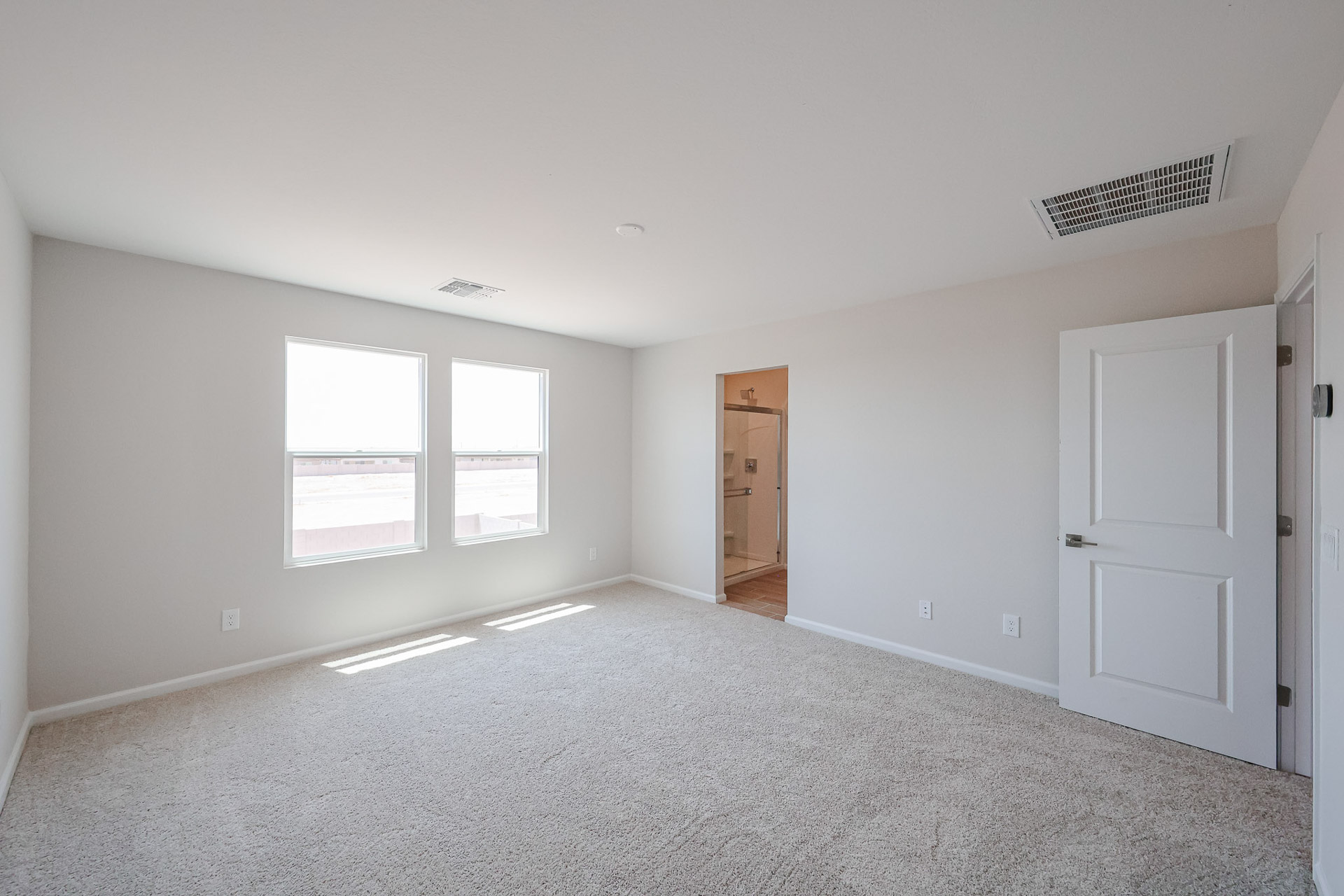A room with white walls and a door.