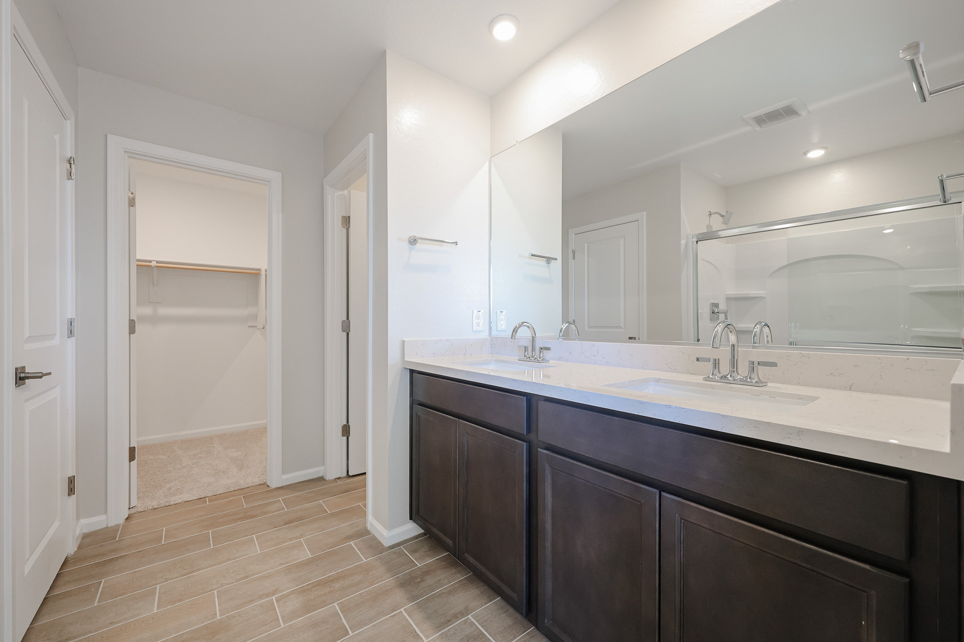 A bathroom with a large mirror.
