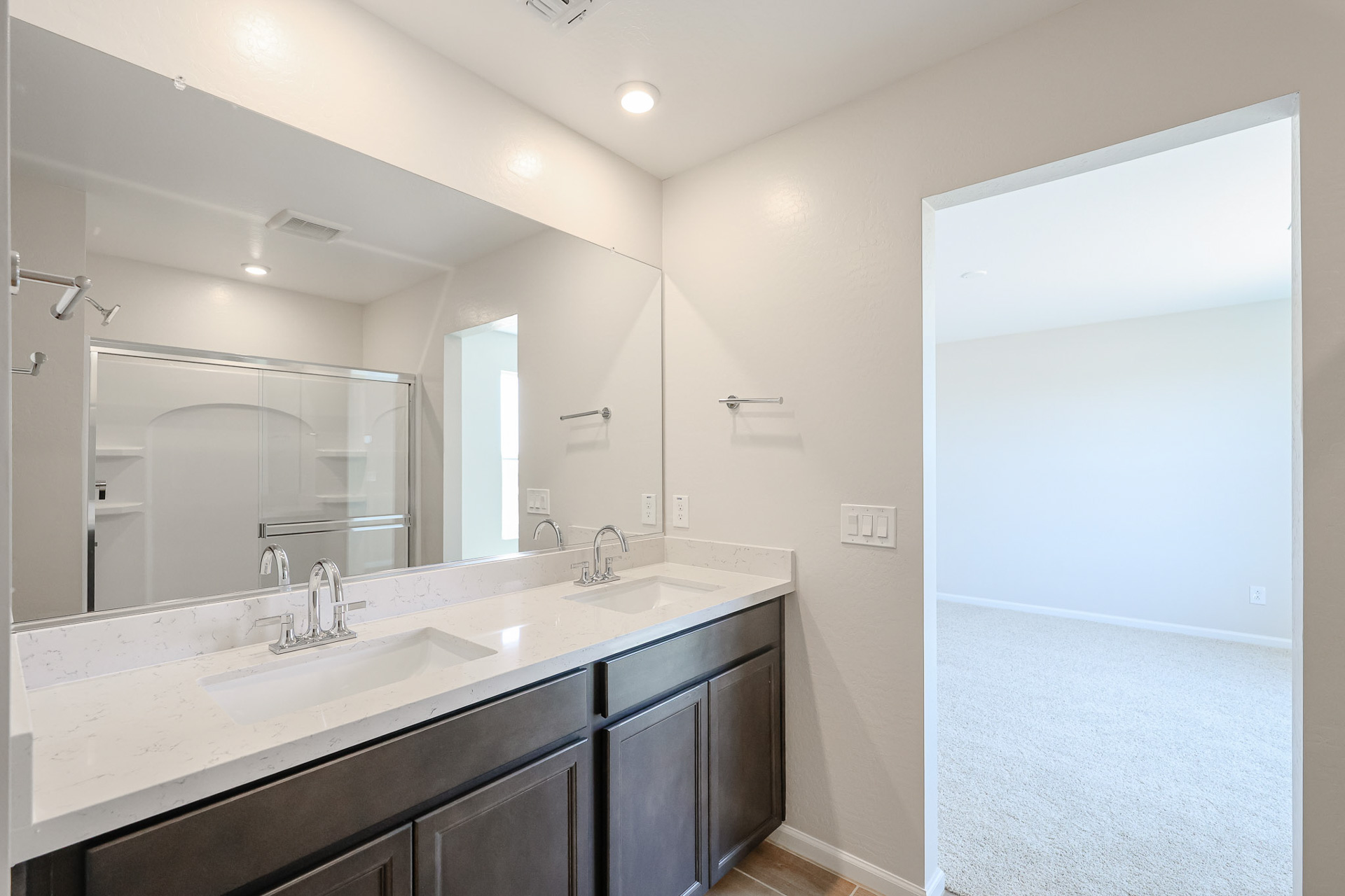 A bathroom with a large mirror.