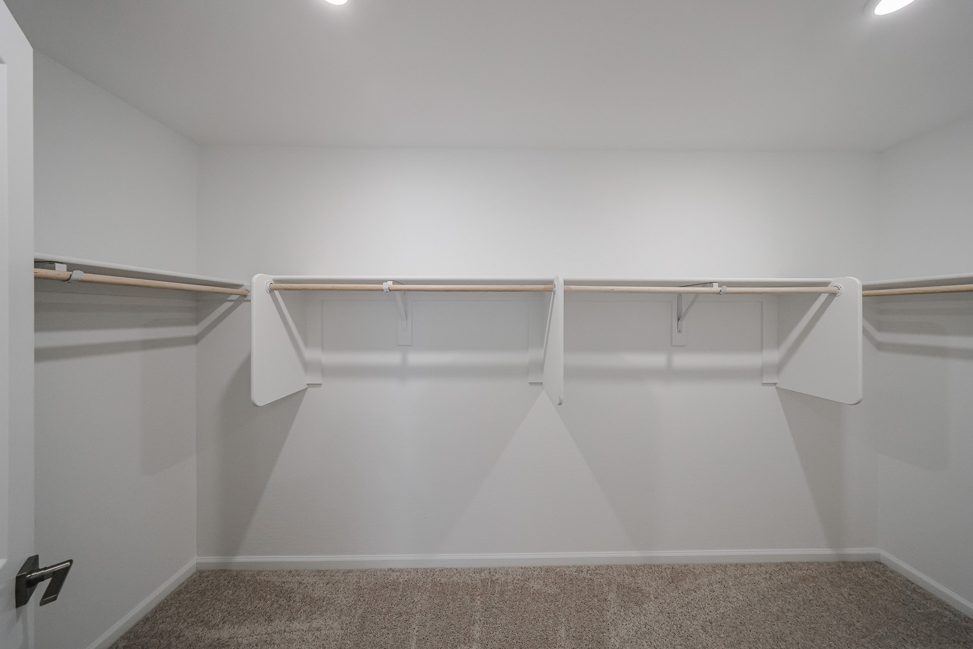 A shower with a metal bar.