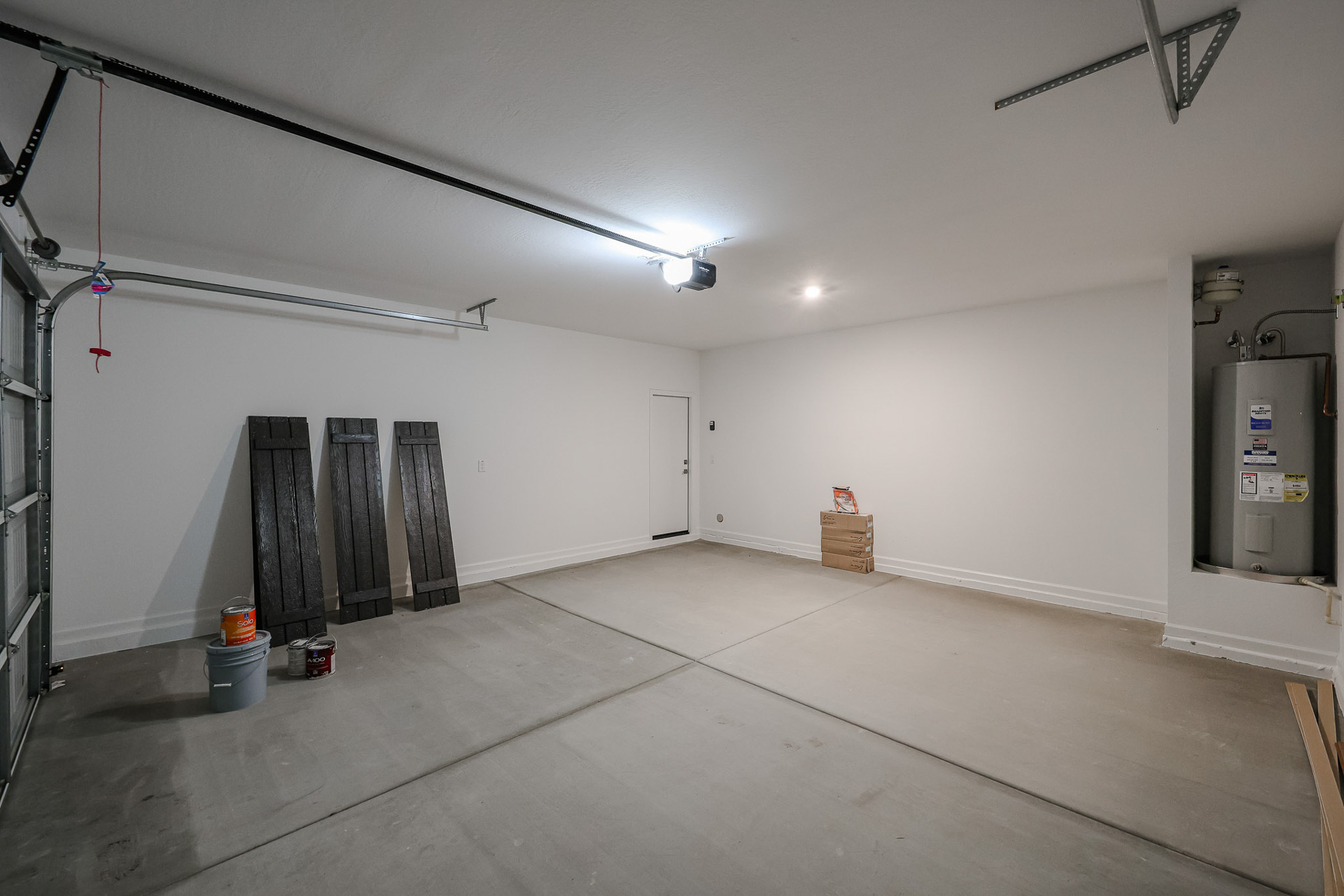 A room with a white wall and a metal box with a metal box.