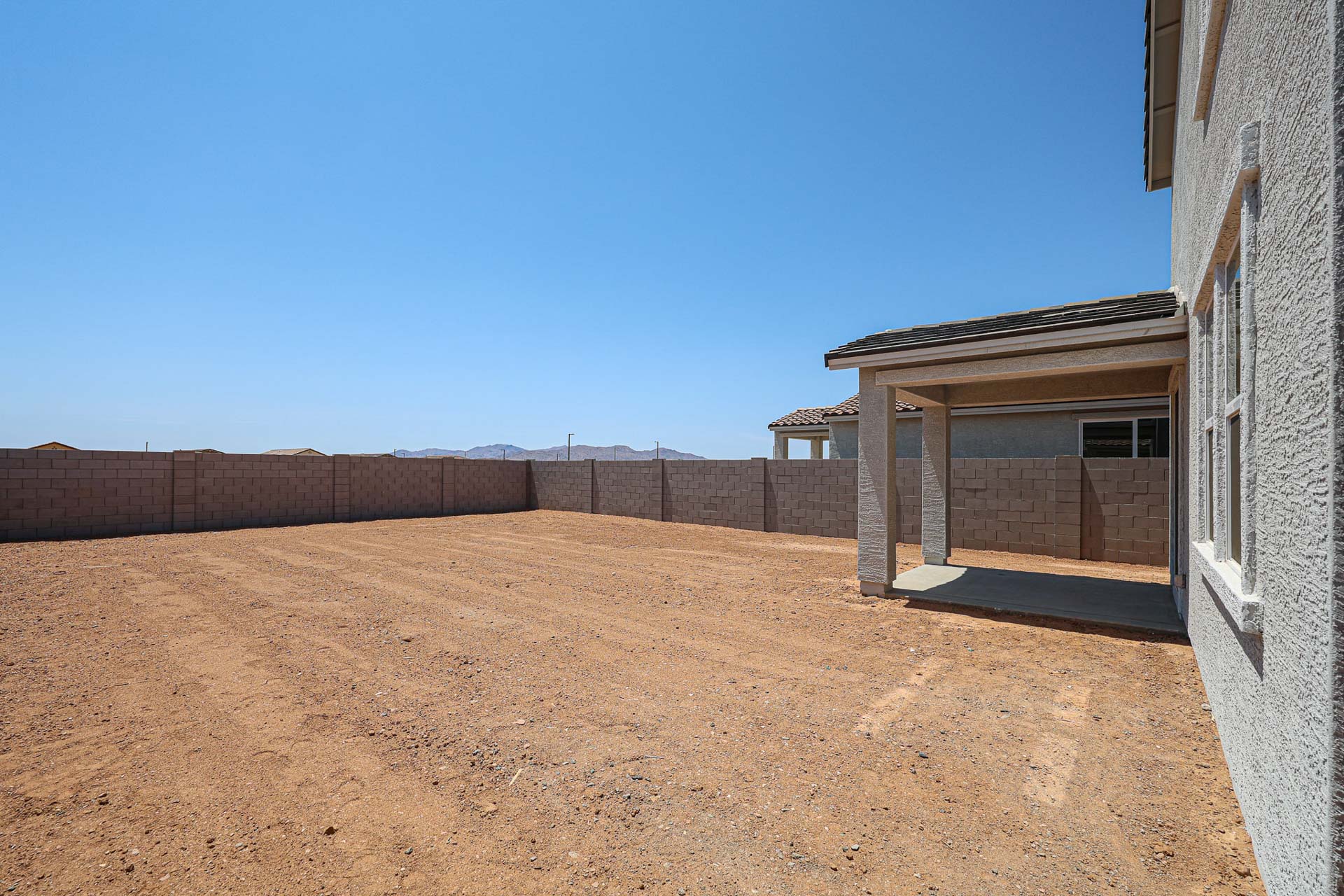 A dirt road with buildings on either side of it.