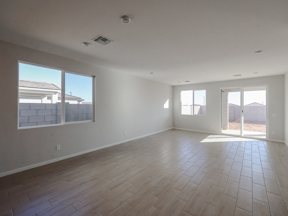 A room with windows and a wood floor.