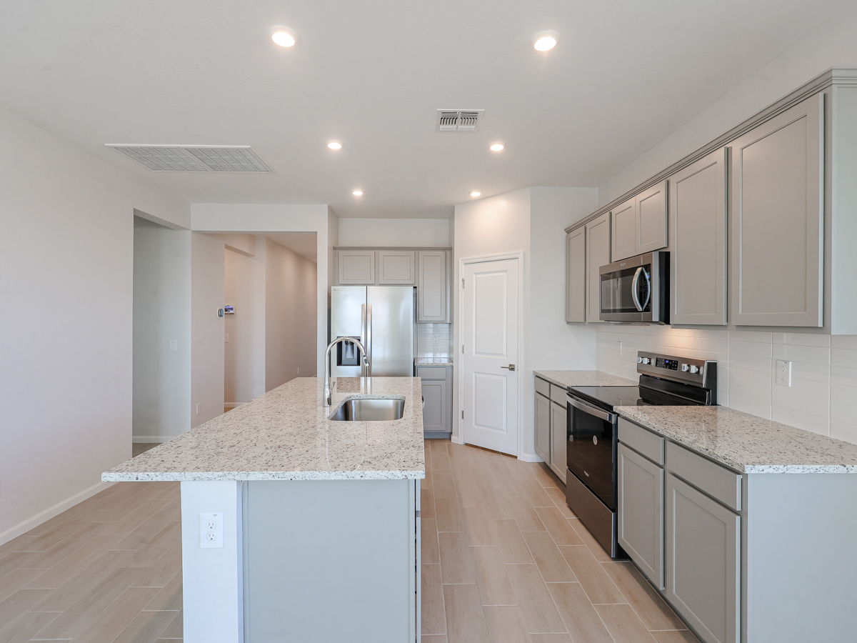 A kitchen with white cabinets.