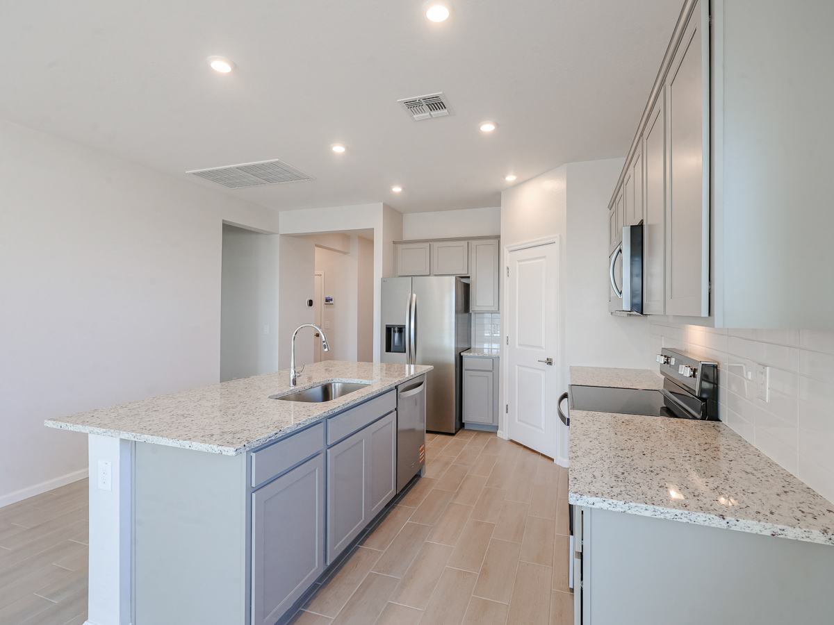 A kitchen with white cabinets.