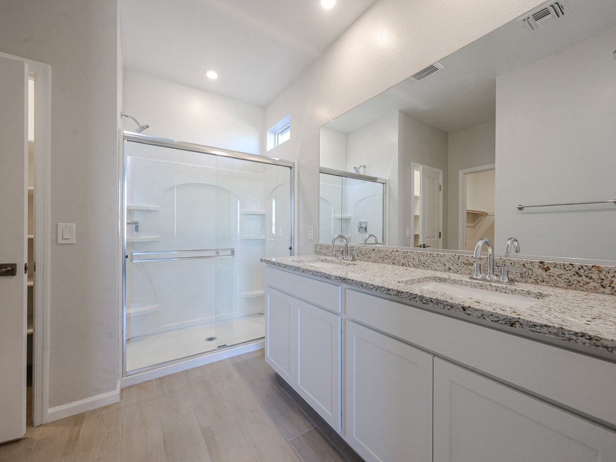 A bathroom with a large mirror.