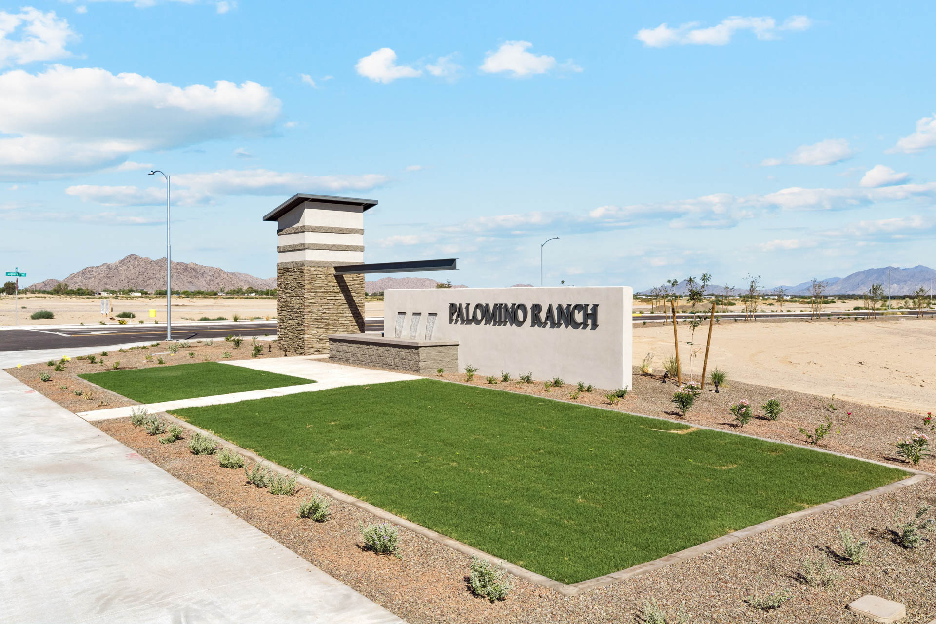 A sign on a grassy area.