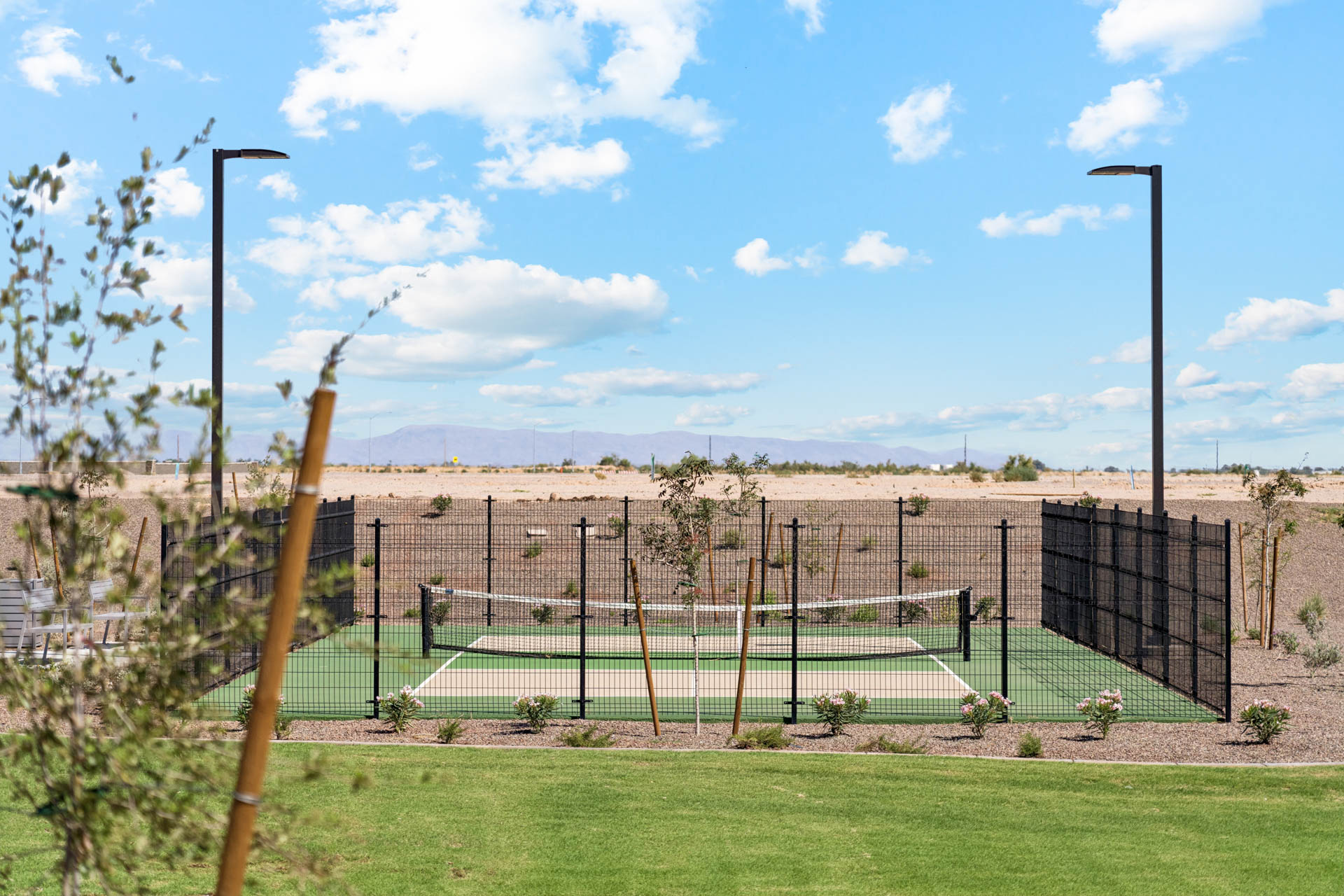 A tennis court with a fence.