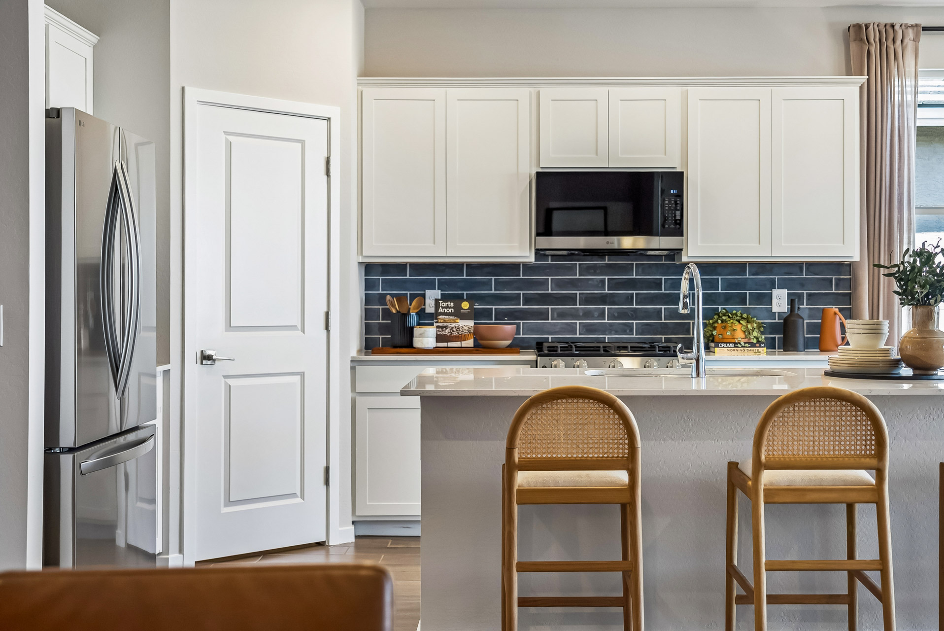 A kitchen with white cabinets.