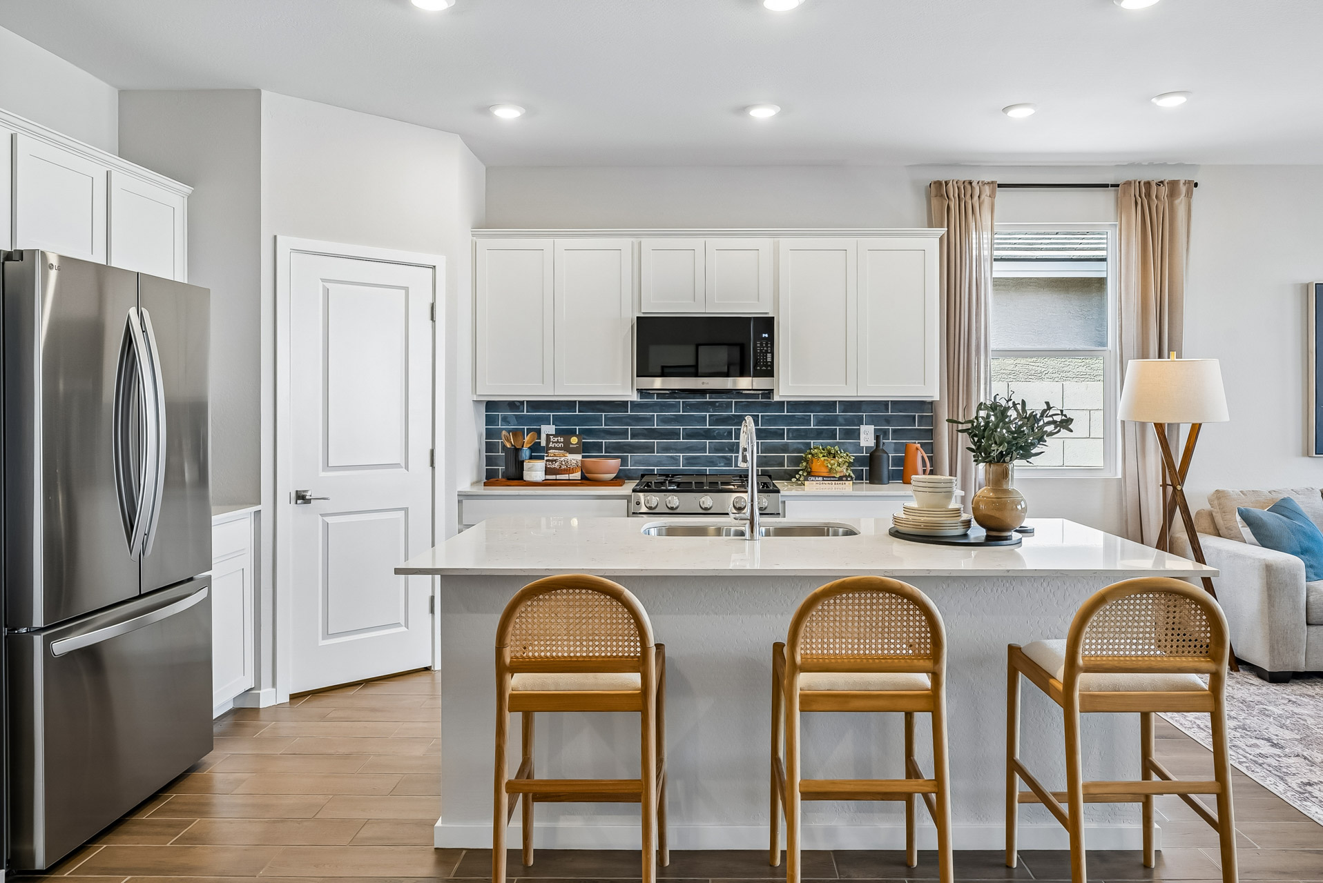 A kitchen with a table and chairs.