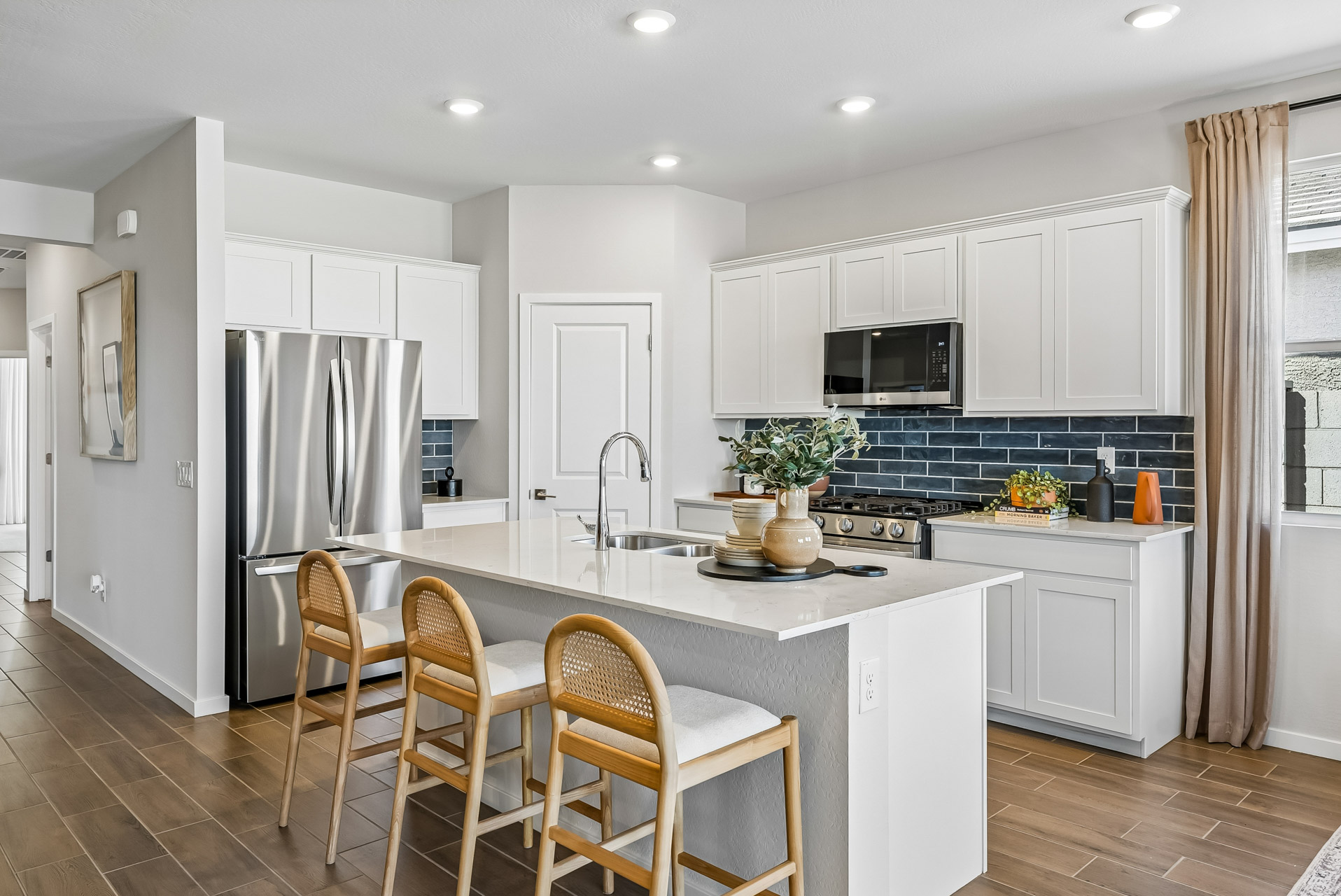 A kitchen with white cabinets.