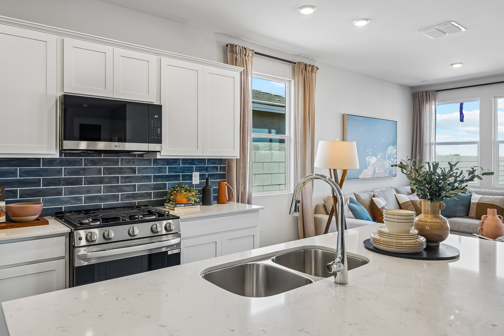 A kitchen with white cabinets.