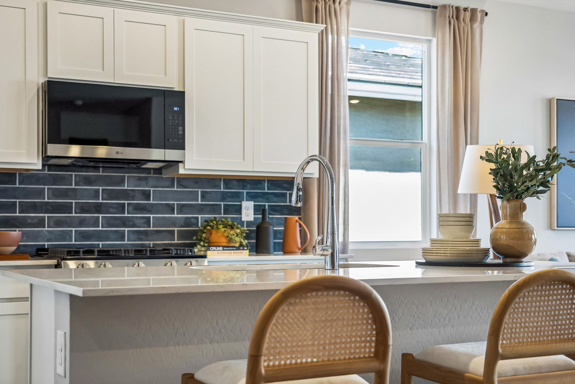 A kitchen with white cabinets.