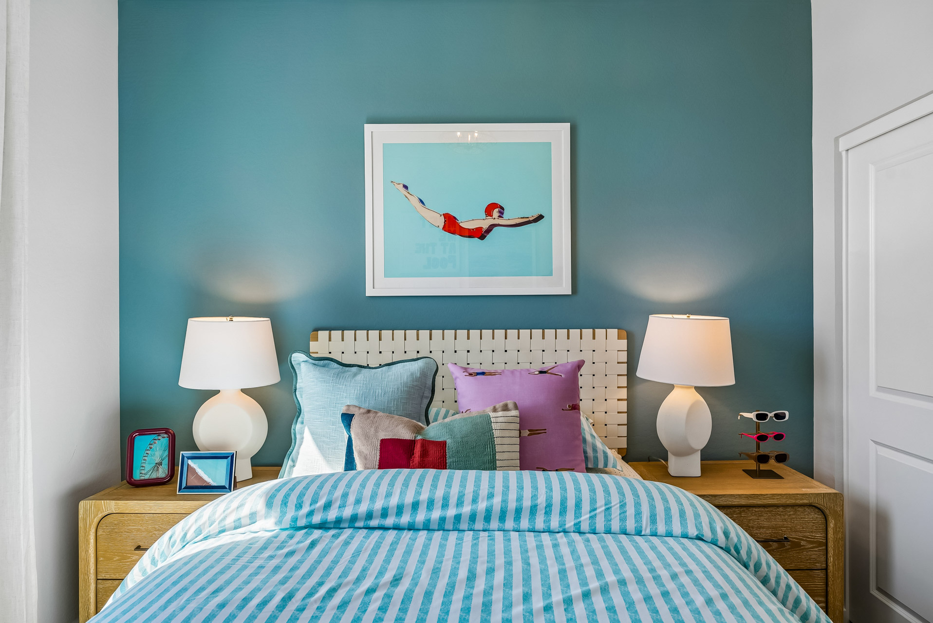 A bedroom with a bed and lamps.