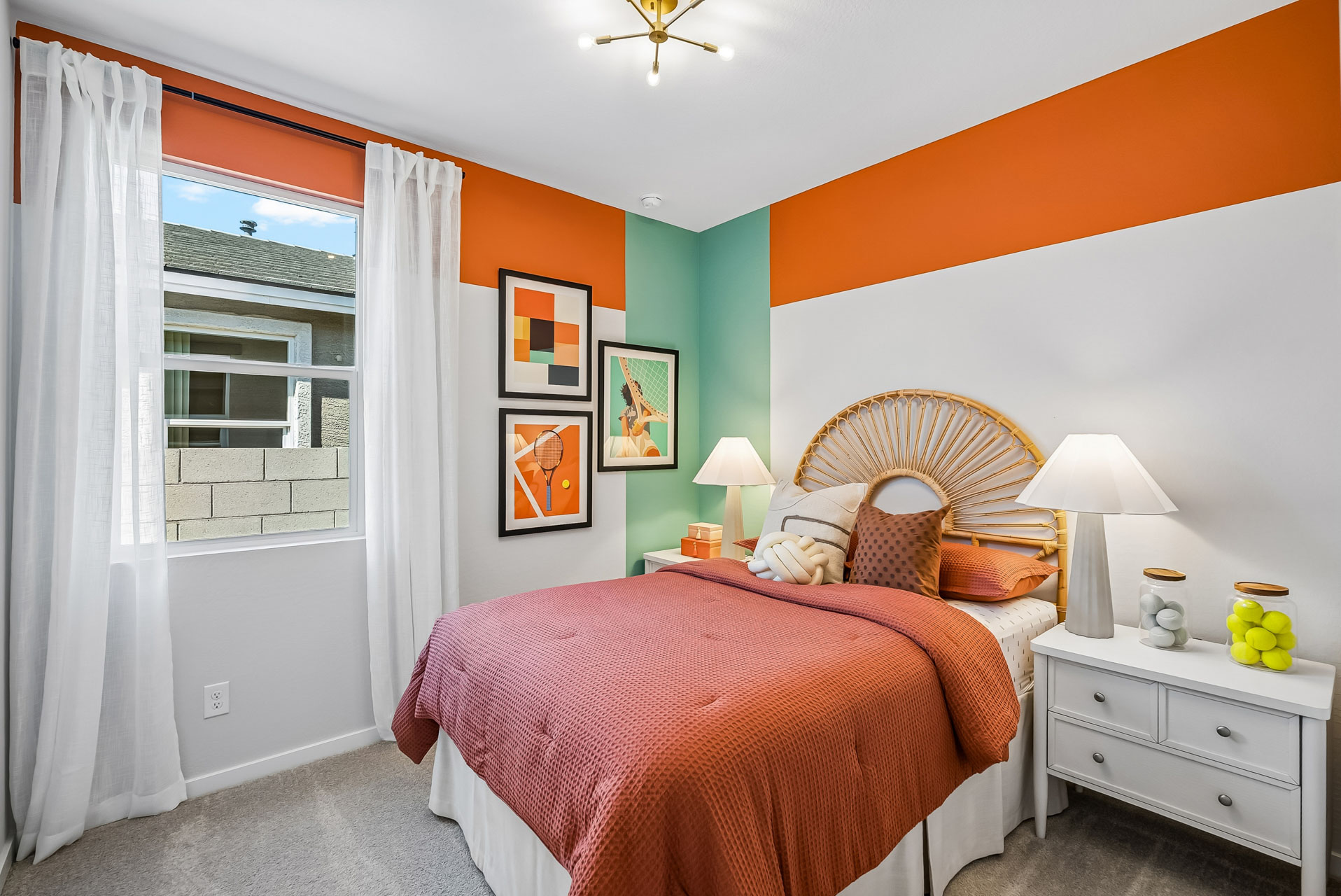A bedroom with a bed and a window.
