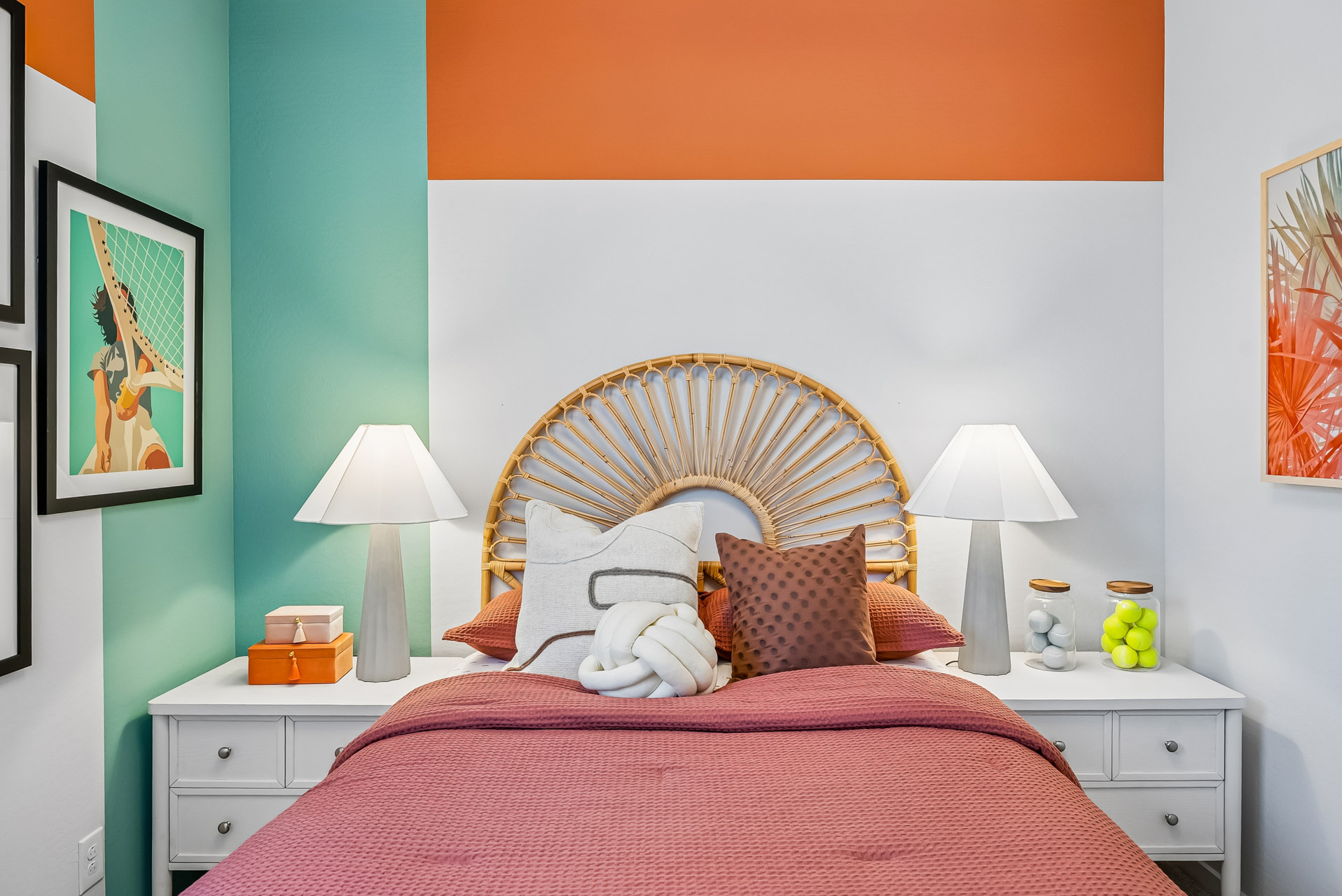 A bedroom with a bed and lamps.
