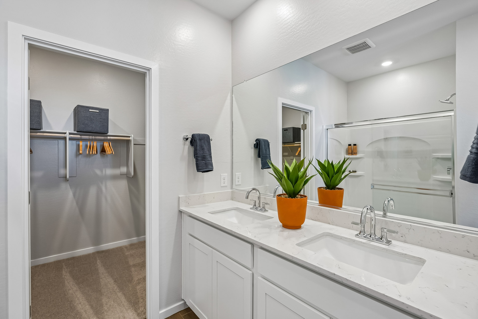 A bathroom with a sink and a shower unit.