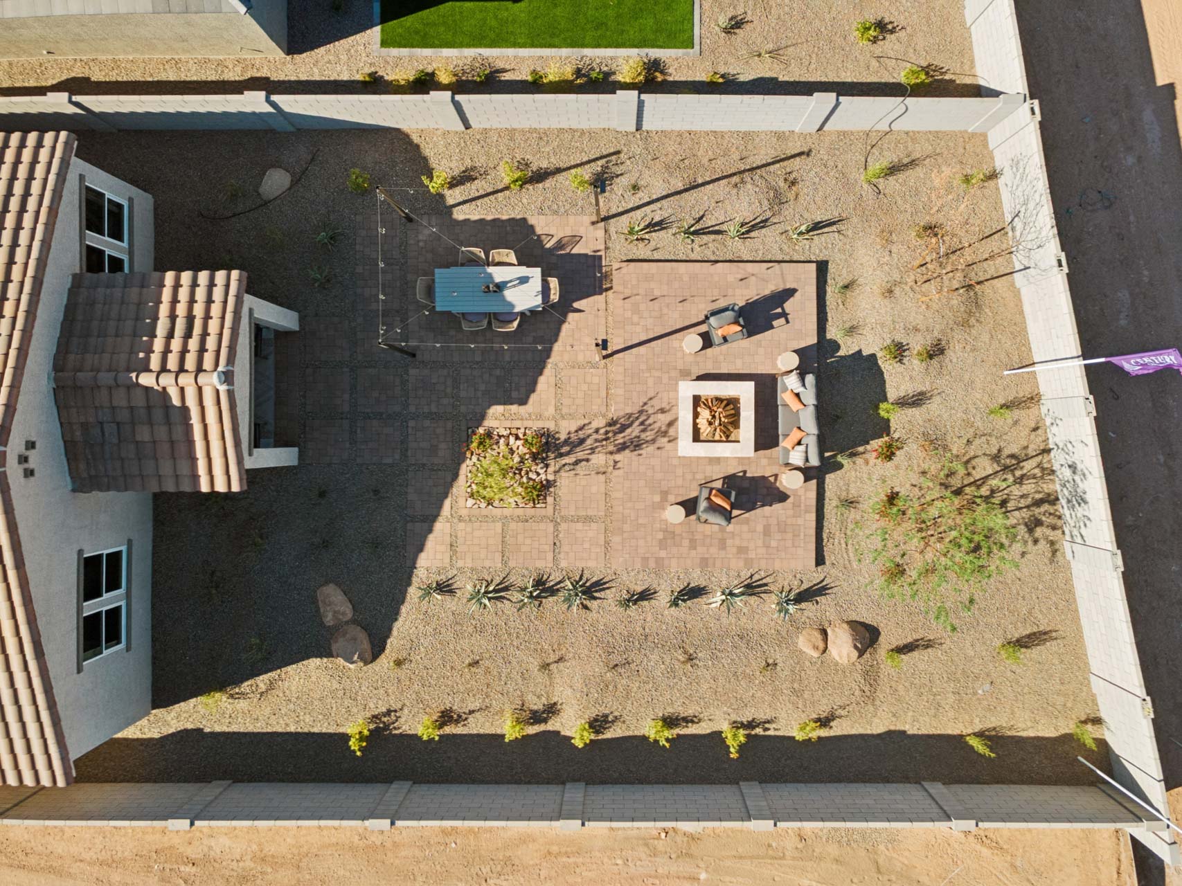A house with a yard and a small pond.