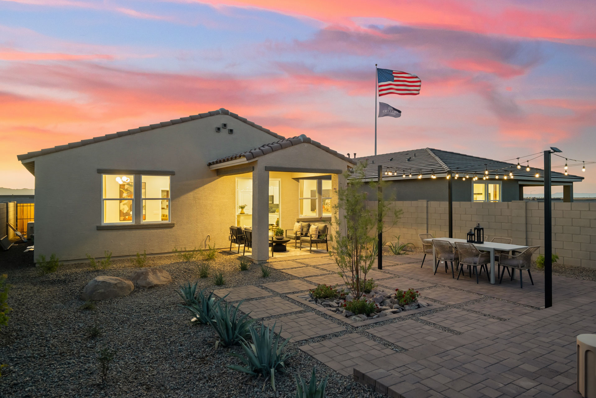 A building with a brick patio and a flag pole and a brick patio.