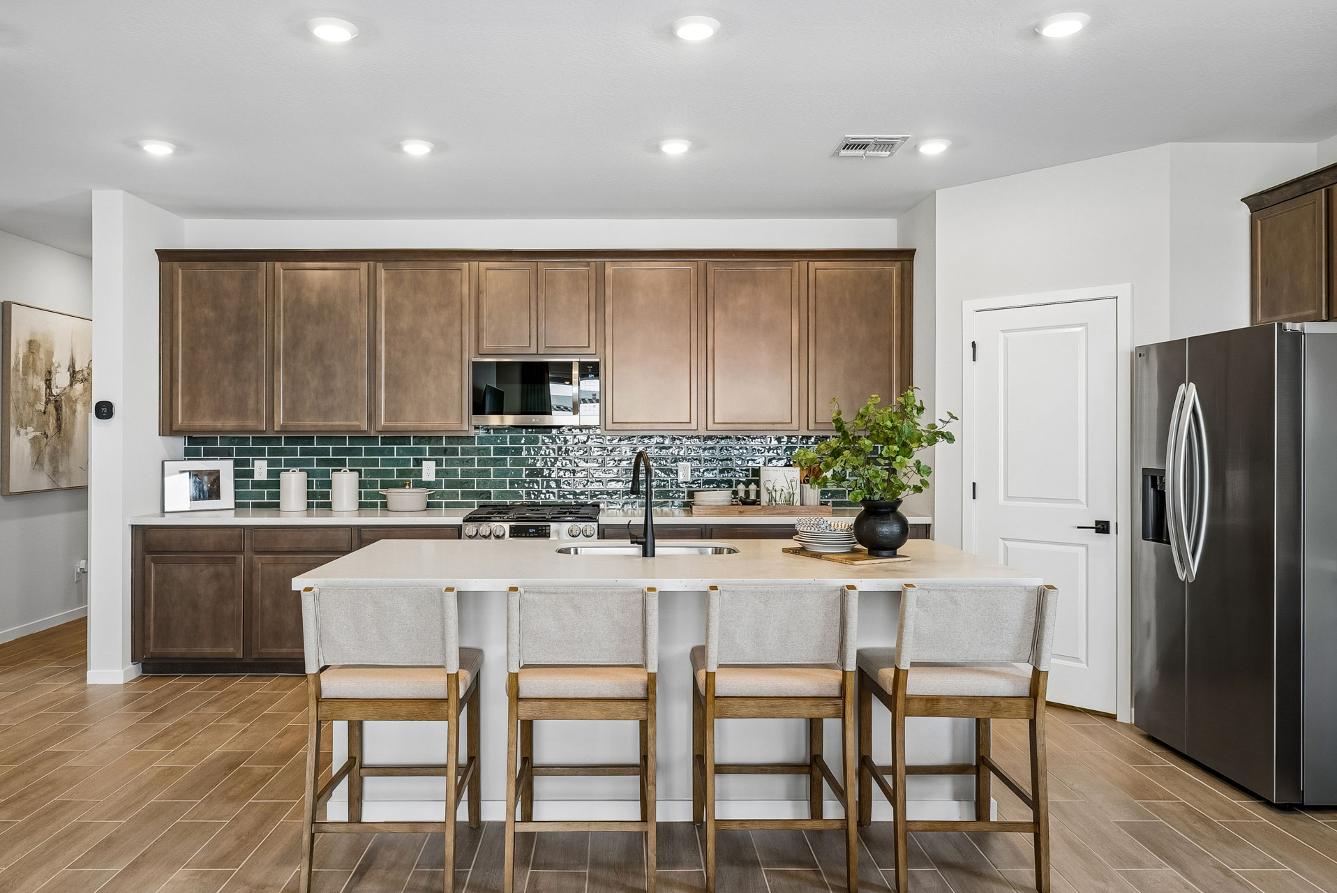 A kitchen with a table and chairs.