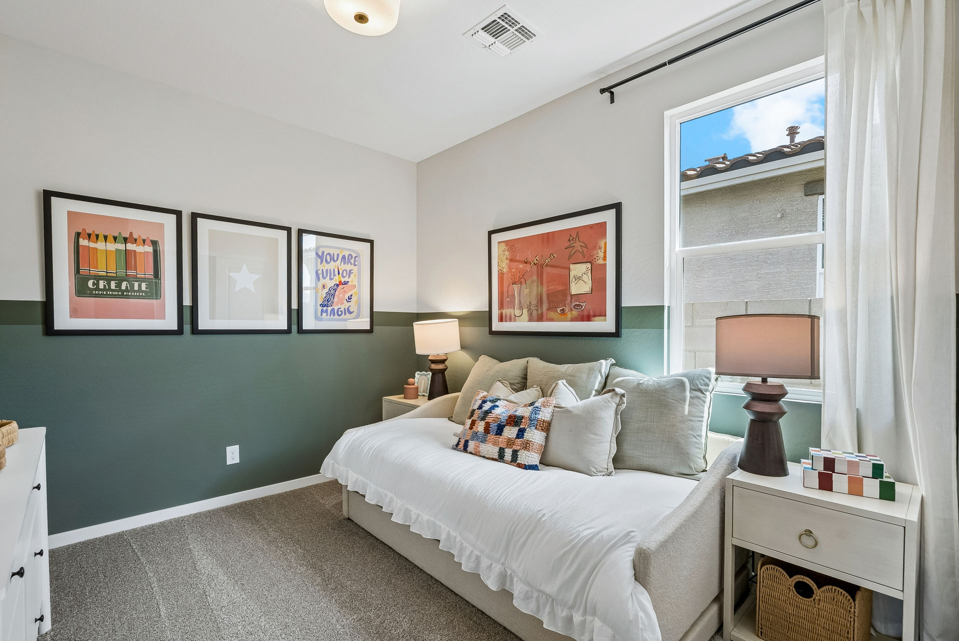 A bedroom with a bed and a lamp.