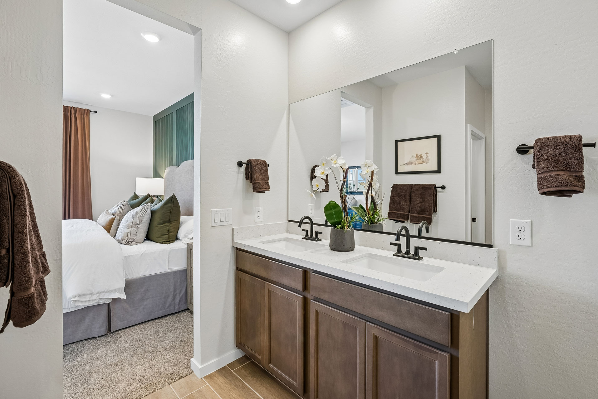 A bathroom with a sink and a bed.
