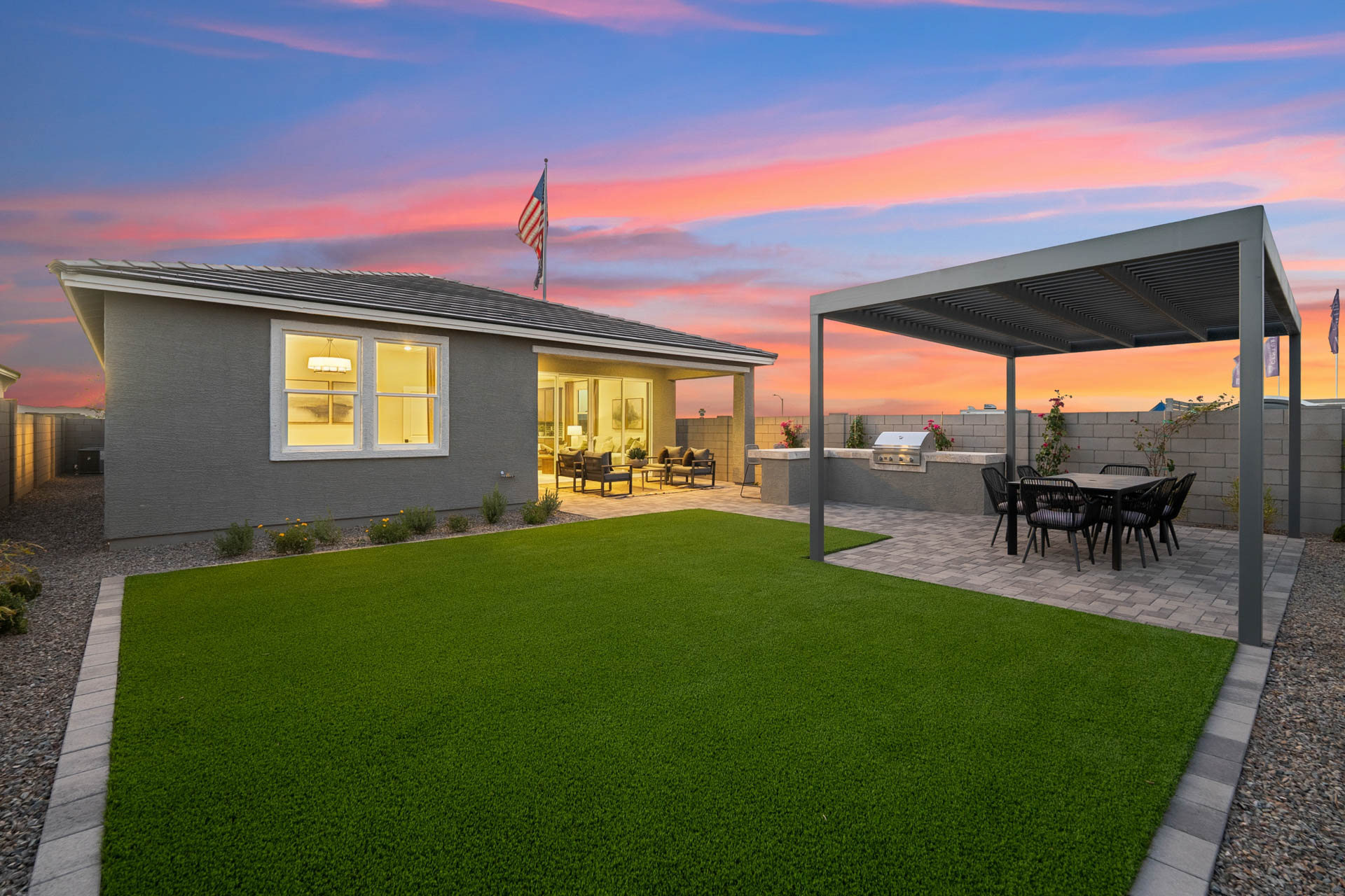 A house with a pool and a large lawn.